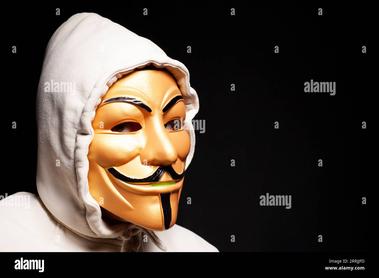 Moscow, Russia, September 03, 2023 Hacker wearing hood and gold