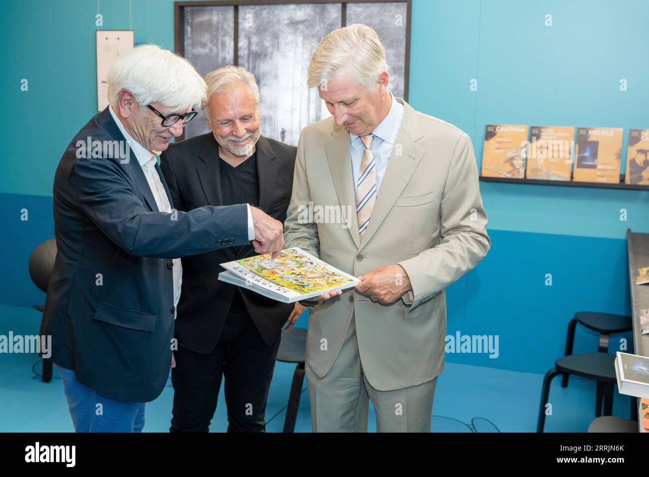 Comic author and cartoonis Johan De Moor and journalist and curator of the exposition Thierry Bellefroid hand over a special edition of 'Journal Tintin' to King Philippe - Filip of Belgium during a royal visit to the exhibition 'Le Lombard, a family business' at the Belgian Comic Strip Center in Brussels, Friday 08 September 2023. To highlight the 77th anniversary of publisher Le Lombard, the publisher is also publishing a special edition of Le Journal de Tintin. With this visit, the King pays tribute to the ninth art, a discipline for which Belgium is known worldwide. BELGA PHOTO JONAS ROOSEN Stock Photo