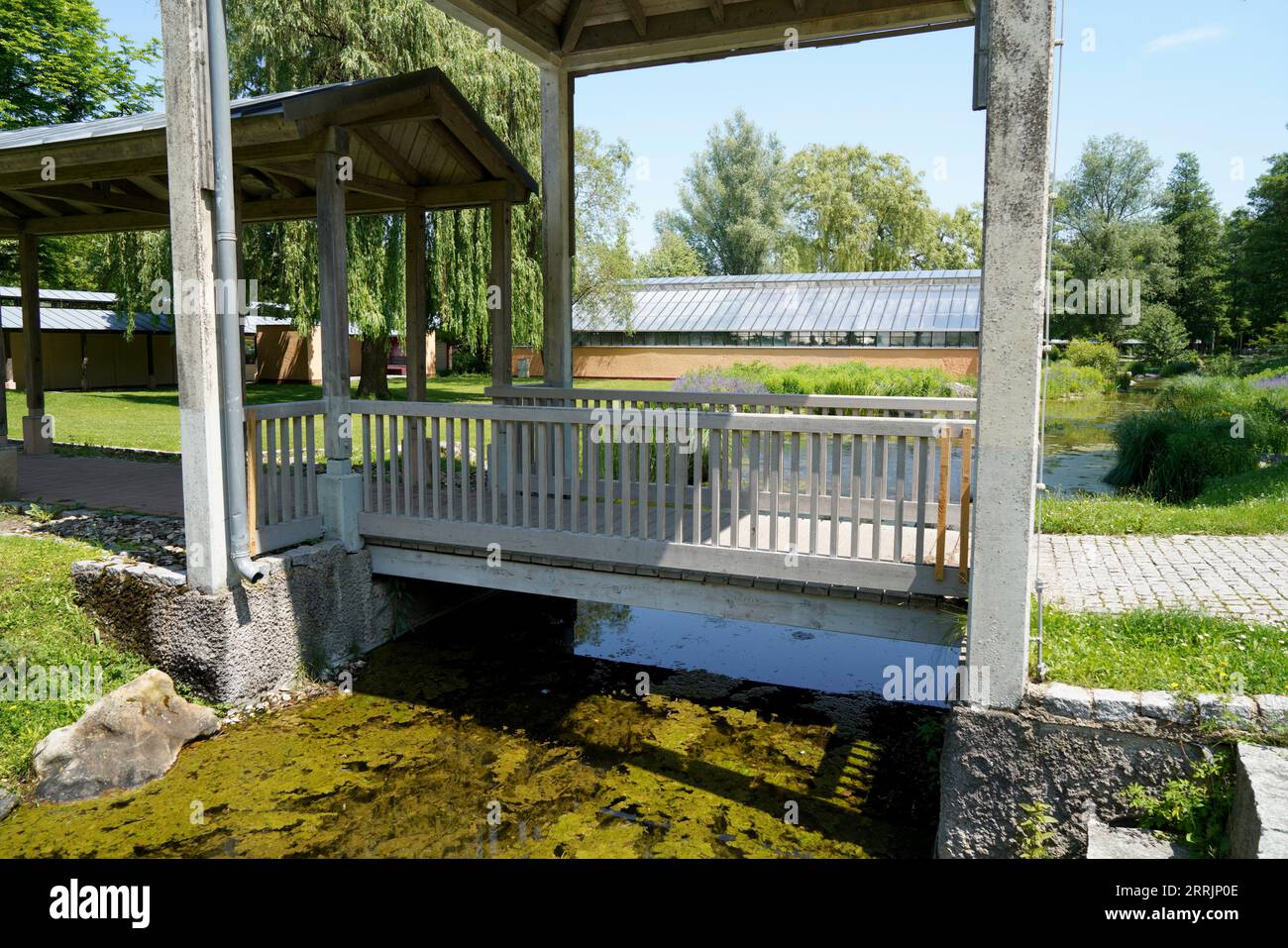 Wooden bridge in the forest that leads over a small stream photographed ...