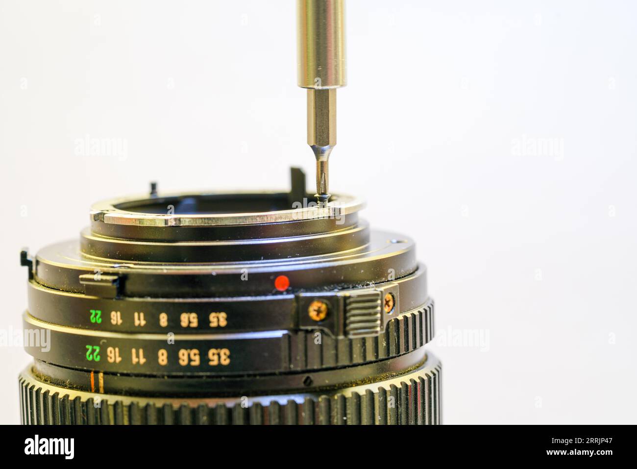 Clean and disassemble the lens for photography into its component parts ...