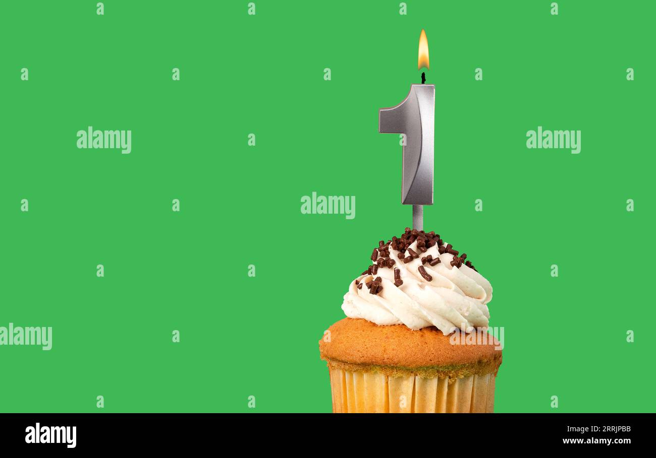 Birthday card with candle number 1 - Cupcake on green background Stock Photo