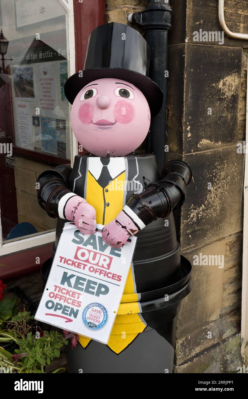 Settle Flowerpot Festival, 2023. A flowerpot Fat Controller from the Thomas the Tank Engine books, supports keeping UK railway ticket offices open. Stock Photo