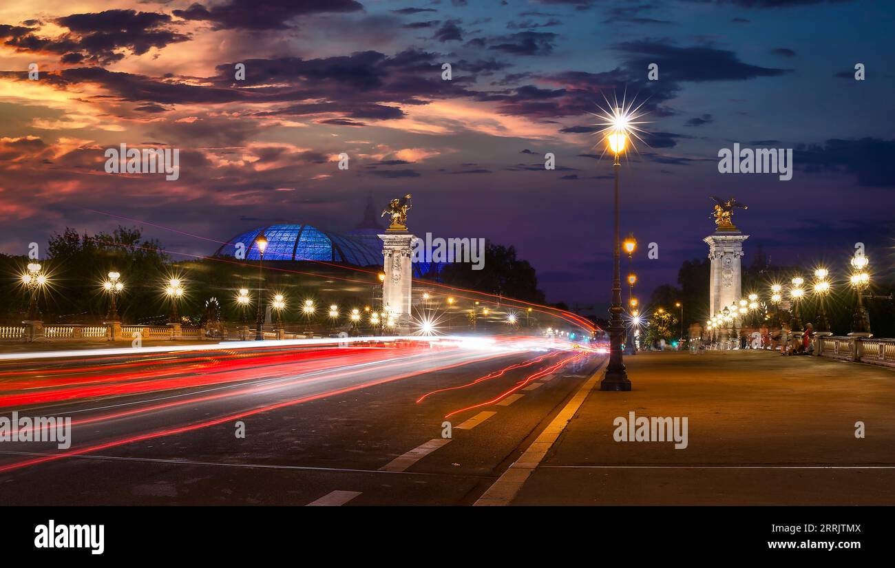 Traffic on Alexandre III bridge in Paris at sunset Stock Photo