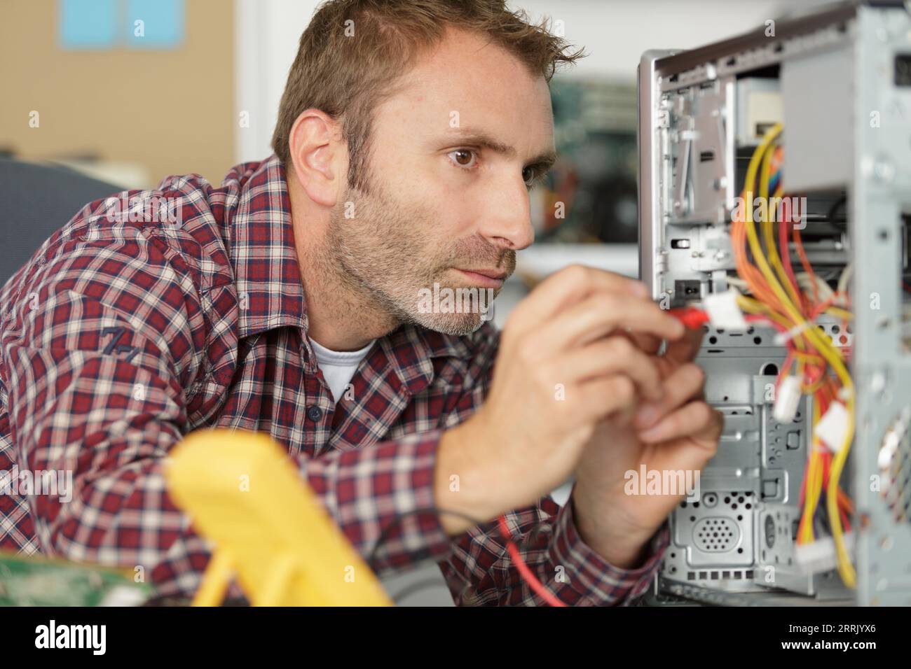Men Repairing Computer a man repairing tower computer Stock Photo - Alamy
