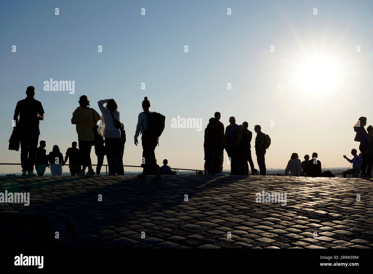 Germany, Bavaria, Munich, Olympic center, Olympiaberg, evening sun, group of people, silhouette Stock Photo
