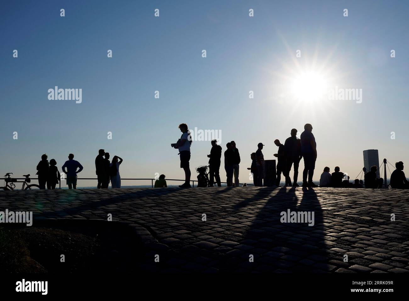 Germany, Bavaria, Munich, Olympic center, Olympiaberg, evening sun, group of people, silhouette Stock Photo