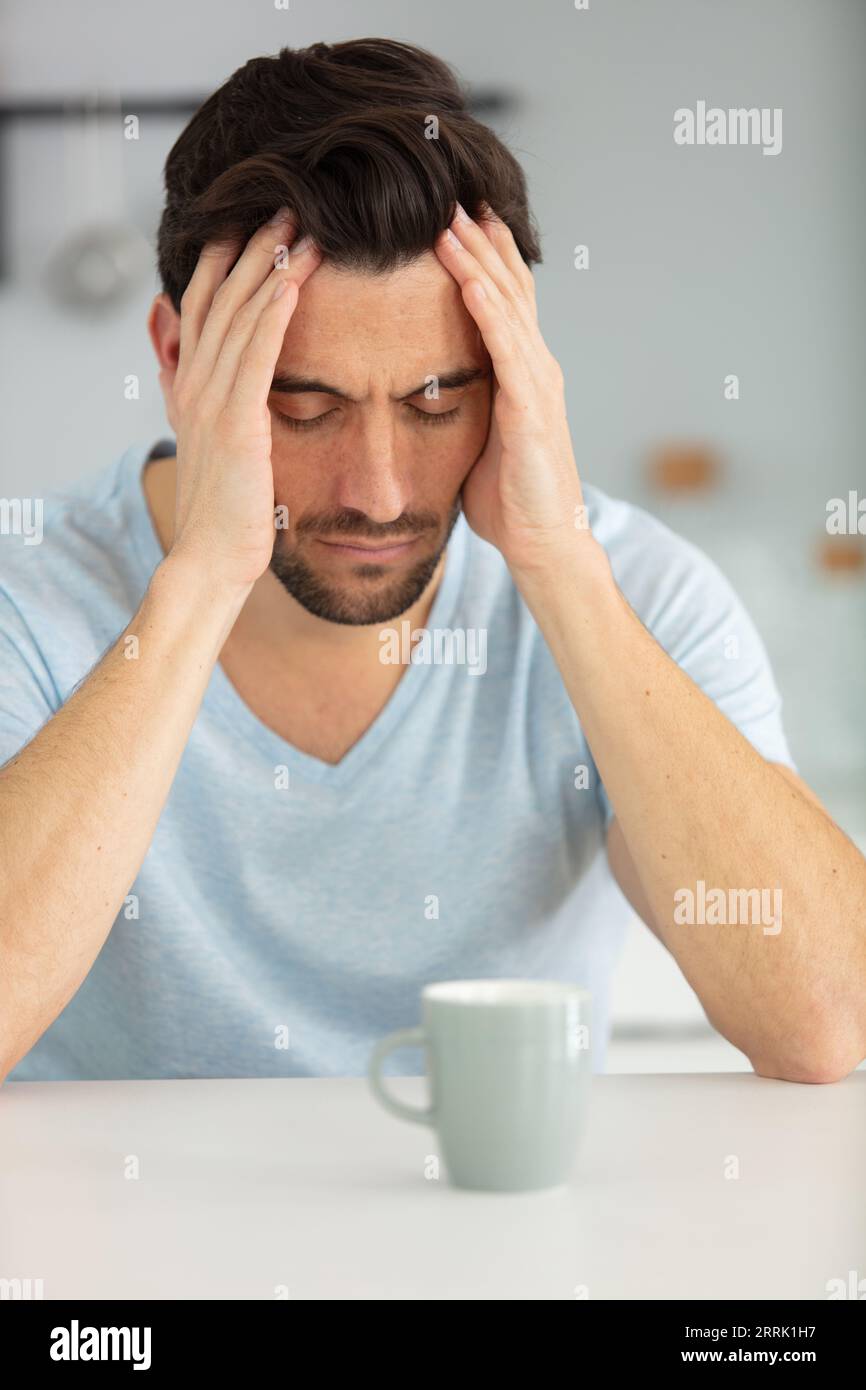 young man having breakfast unhappy and frustrated Stock Photo