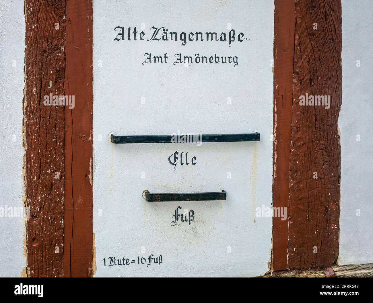 Amöneburg, Hesse, Germany - On the facade of the town museum Amt Amöneburg are the length measures of ELLE and FUSS. Amöneburg is a small town in the central Hessian district Marburg-Biedenkopf. It is located on the 365 m high mountain Amöneburg with the castle Amöneburg at the top. Stock Photo