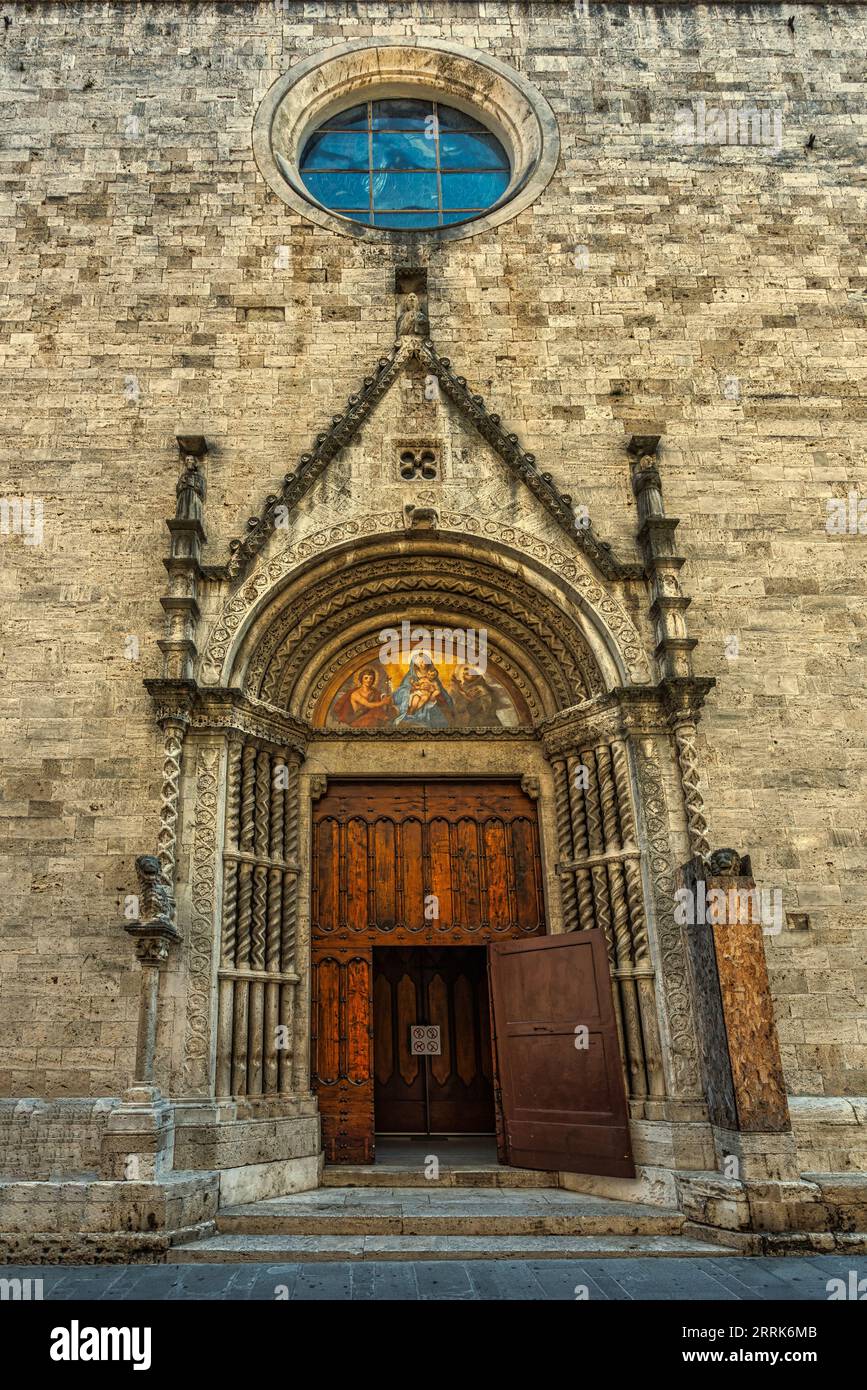 The main portal in style between Romanesque and Gothic is finely decorated and has small columns built with whole pieces of travertine. Ascoli Piceno, Stock Photo
