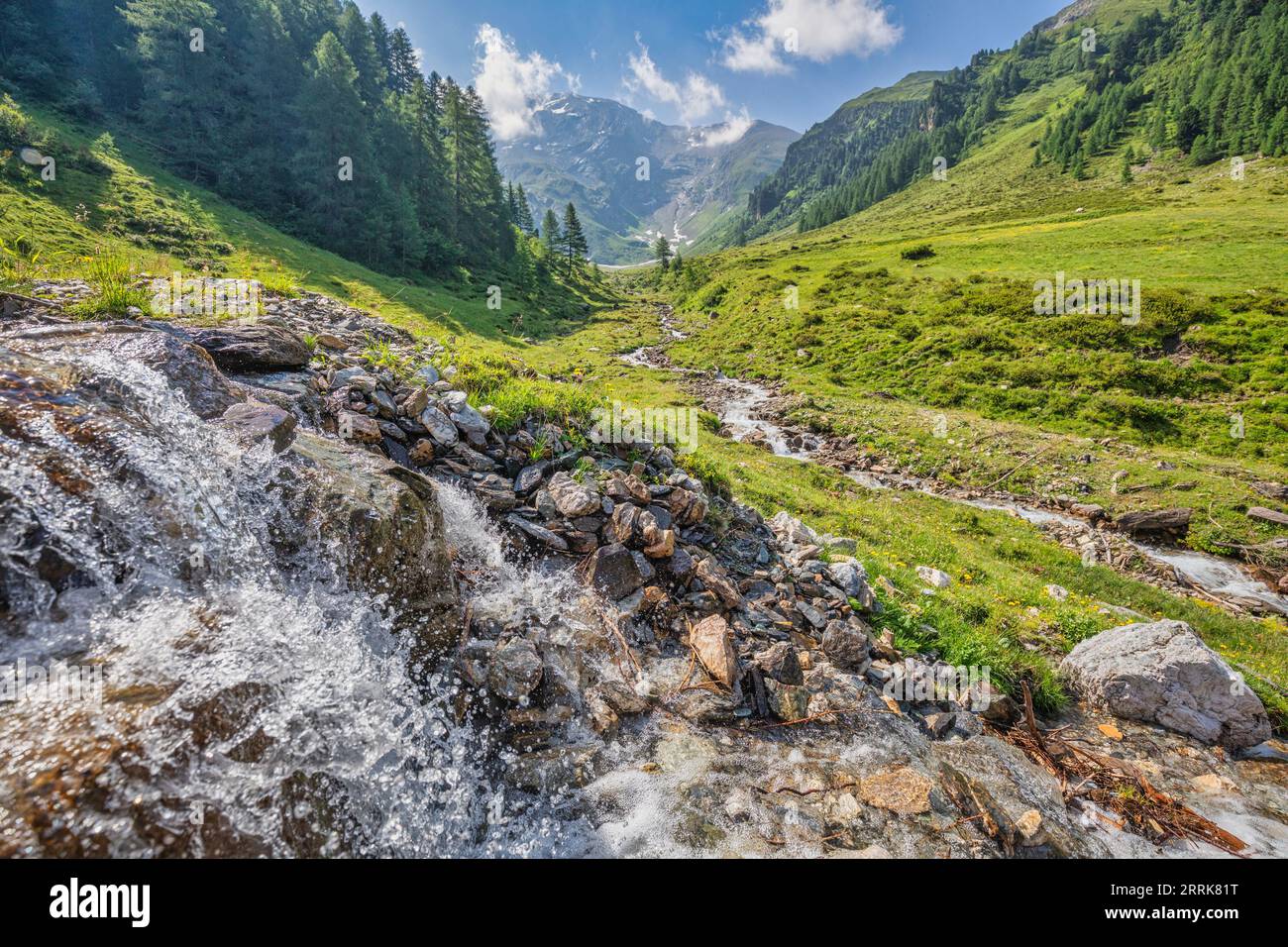 idyllic alpine landscape in the Schmirn Valley with the Kasern stream and high-altitude pastures Stock Photo