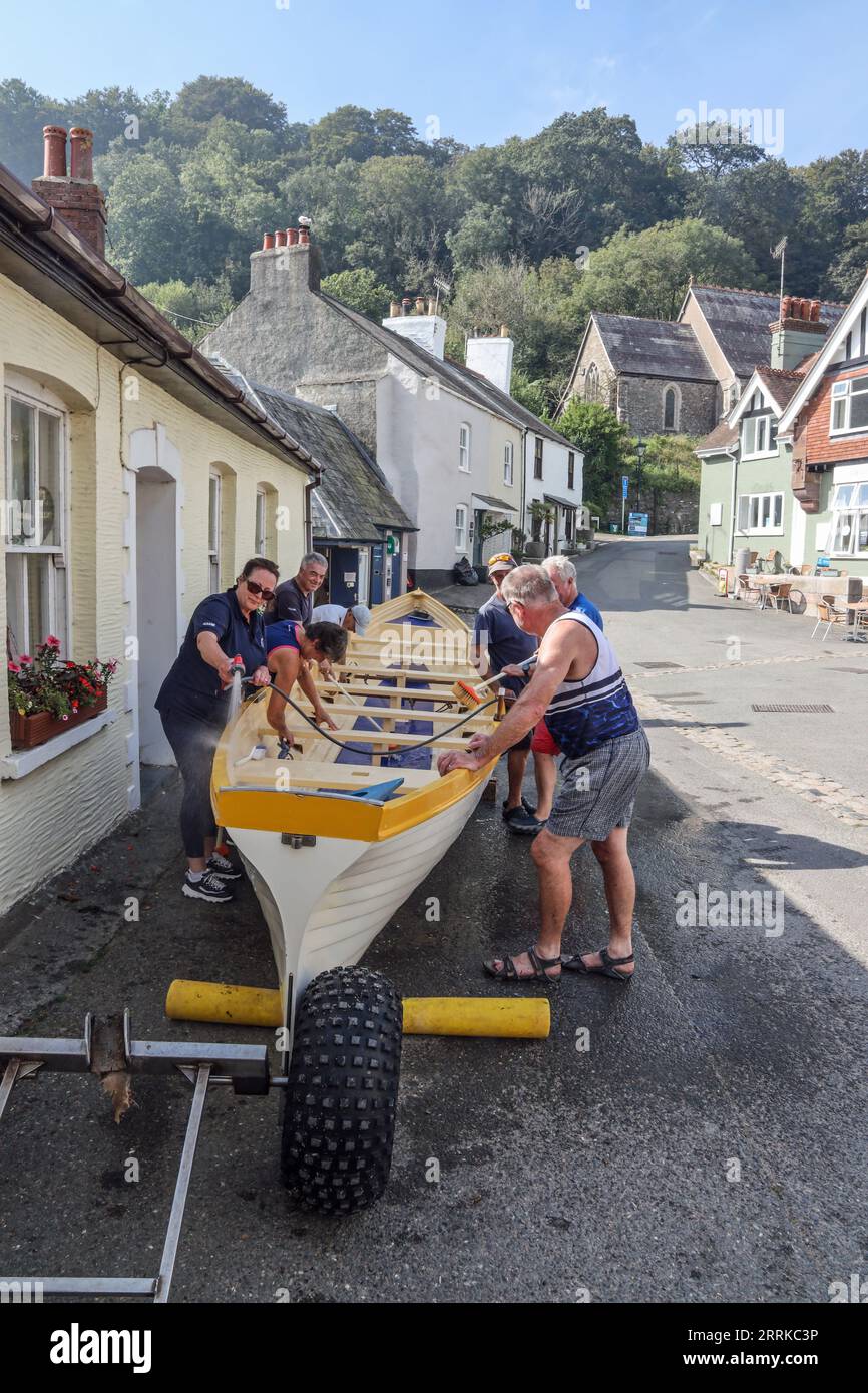 Cawsand Square in south east Cornwall on the often overlooked Rame Peninsula. In the distance a team givng maintenance to the Maker Wave gig boat. Stock Photo