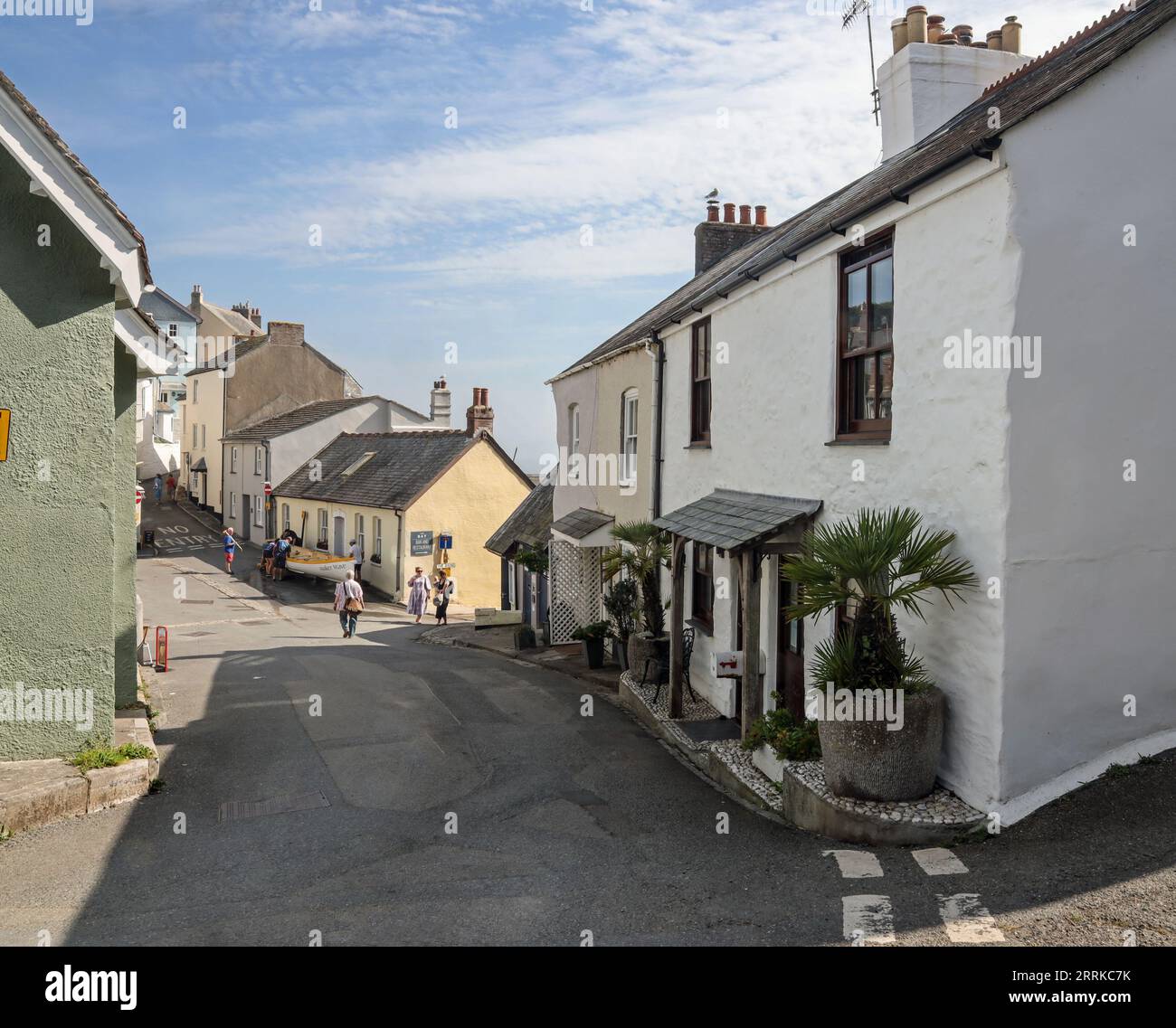 Cawsand Square in south east Cornwall on the often overlooked Rame Peninsula. In the distance a team givng maintainance to the Maker Wave gig boat. Stock Photo