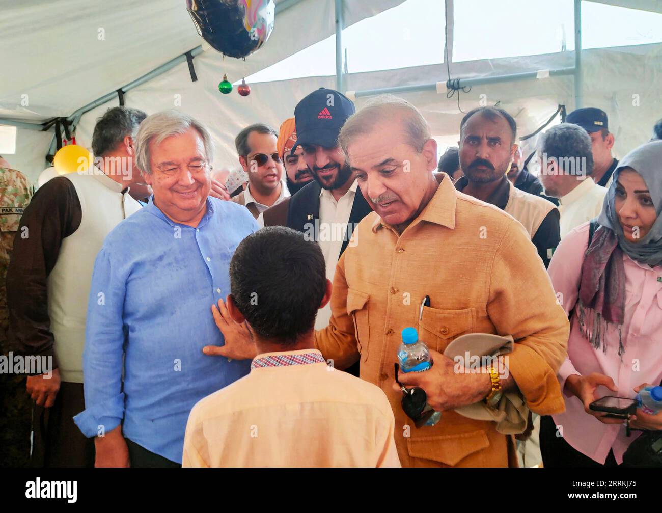 220911 -- BALOCHISTAN, Sept. 11, 2022 -- UN Secretary-General Antonio Guterres 1st L, 2nd row and Pakistani Prime Minister Shahbaz Sharif 2nd R, 2nd row visit flood-affected residents in Balochistan province, Pakistan, Sept. 10, 2022. The secretary-general on Saturday, along with Pakistani Prime Minister Shahbaz Sharif and other officials, visited the flood-affected parts of Pakistan s southern Sindh and southwest Balochistan provinces. Apart from visiting the UNESCO s World Heritage site of Mohenjo Daro in Sindh, which got damaged from the floods, he also met the displaced people in Sindh and Stock Photo