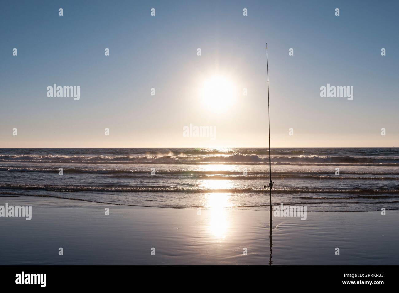 Fishing on the sandy beach by the sea Stock Photo