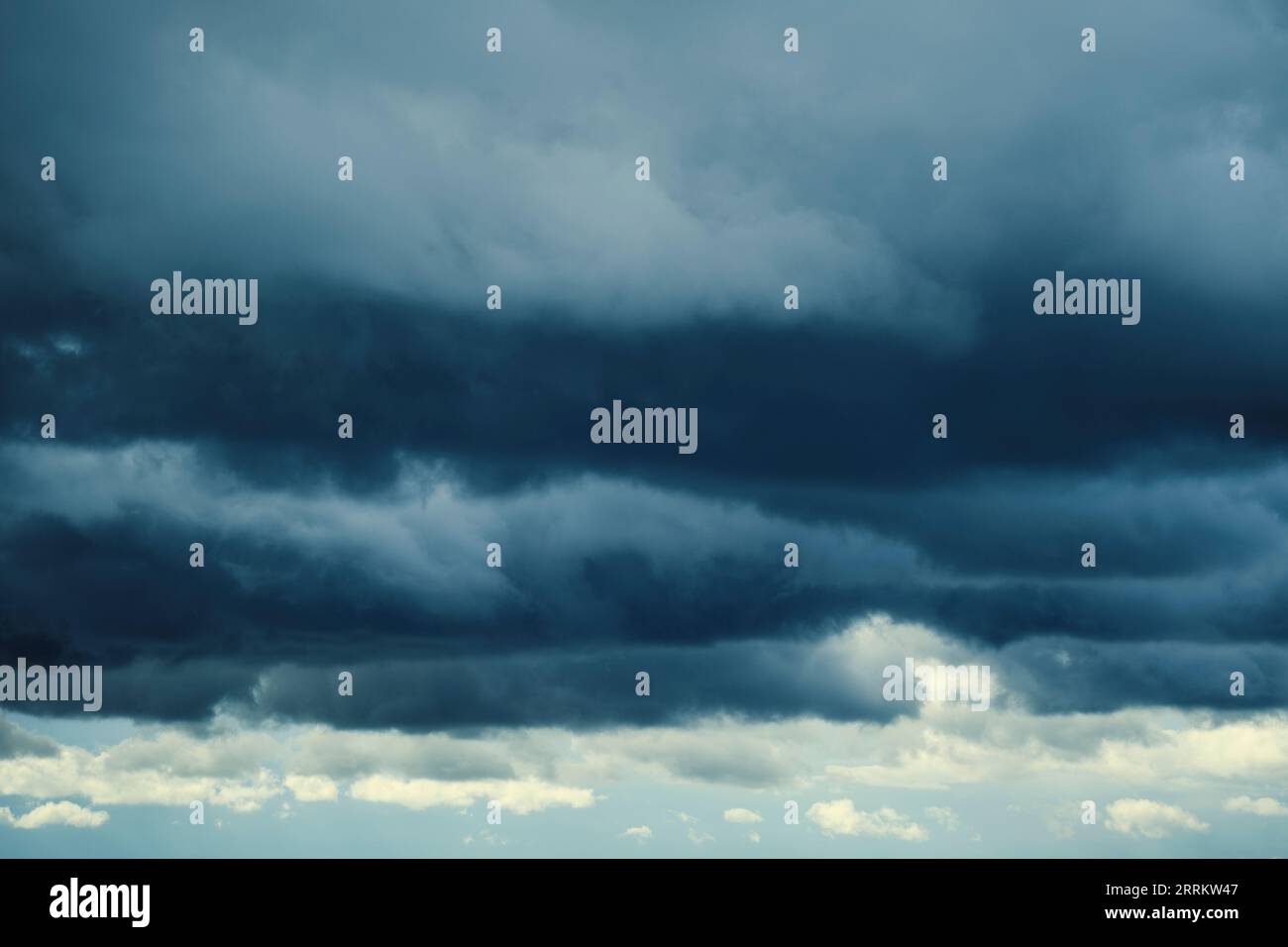 Dark storm clouds with breaking sunlight Stock Photo