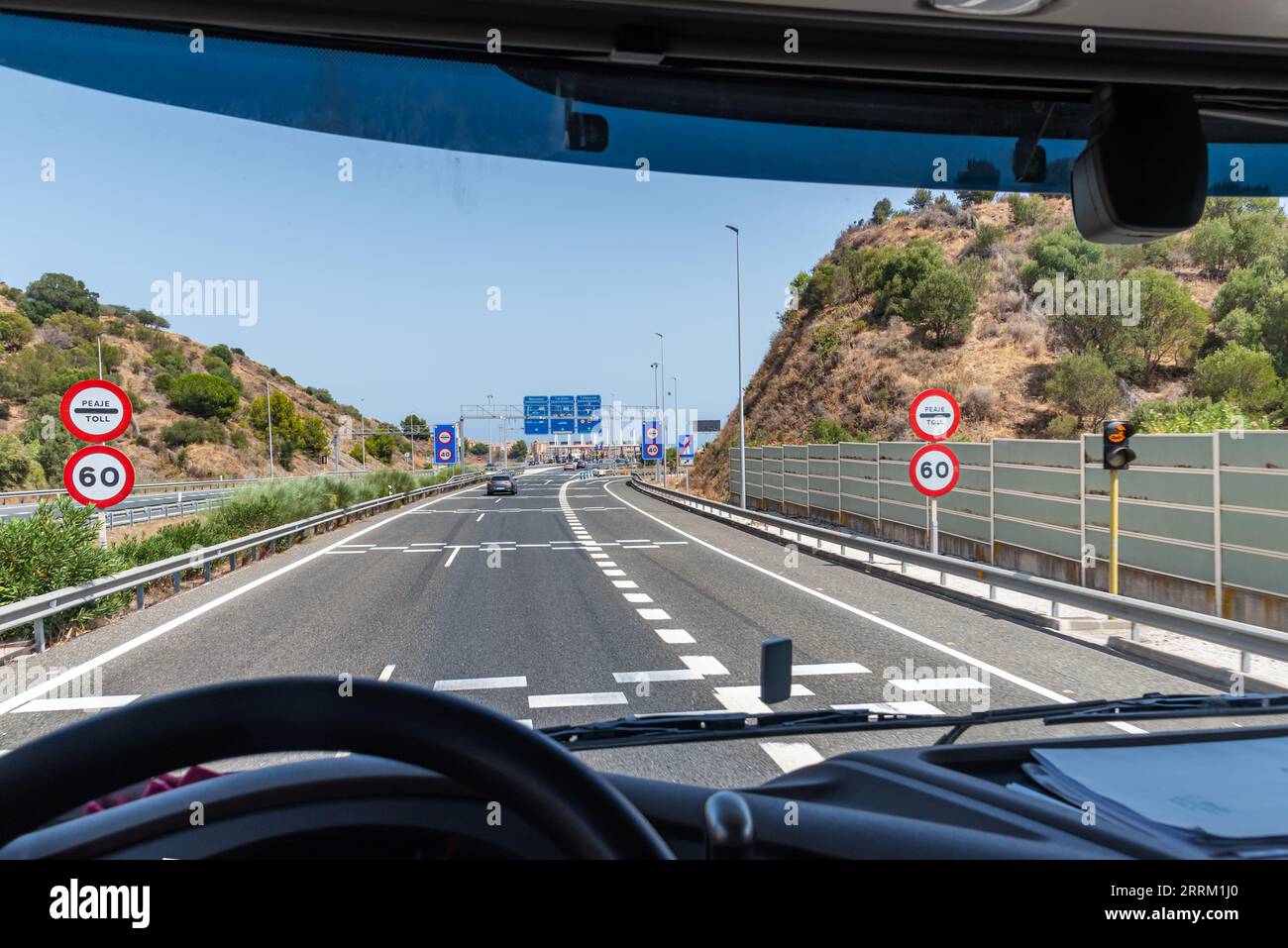 View from the driving position of a truck of the information signs upon arrival at a tollbooth. Stock Photo