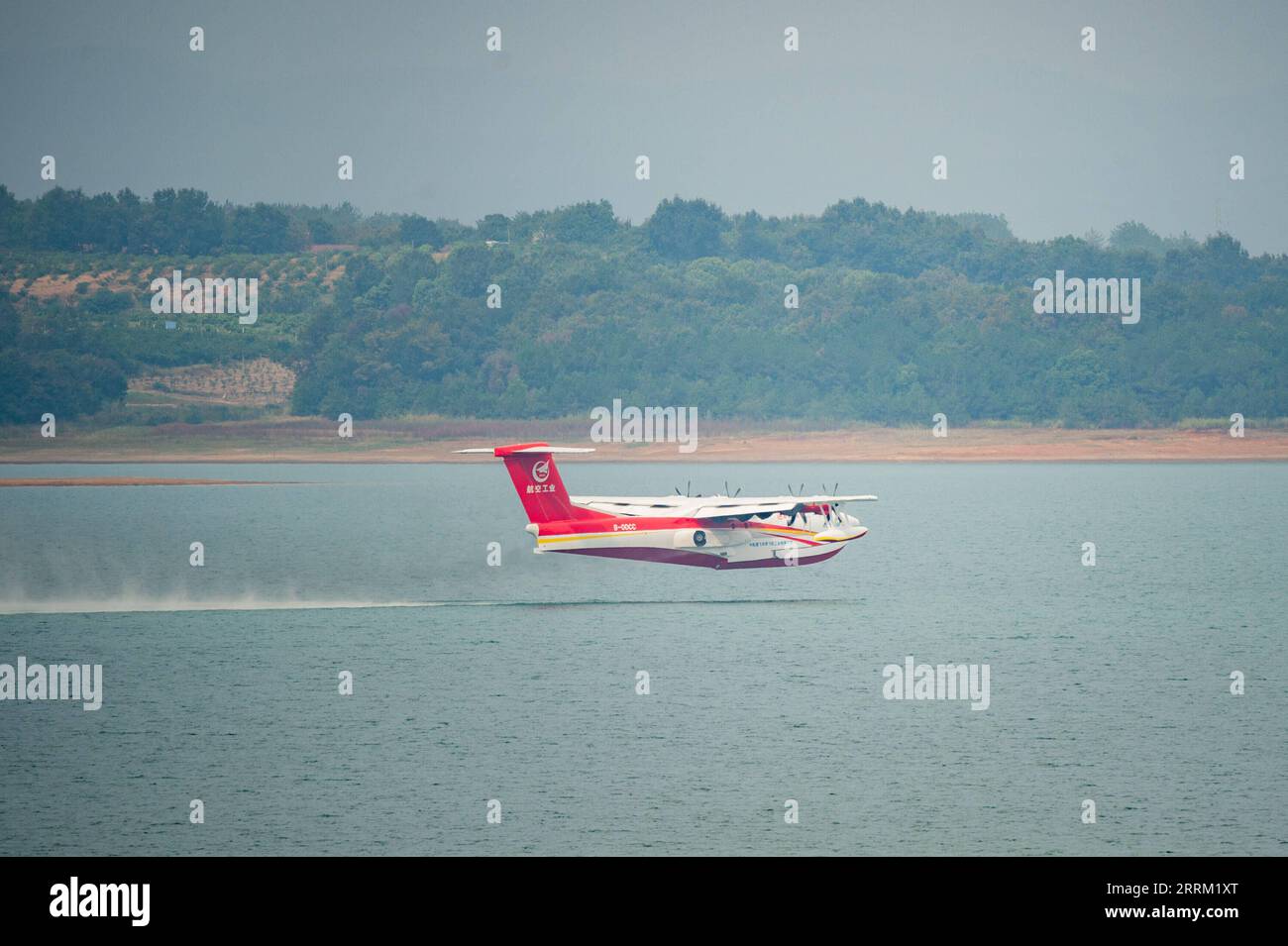 220927 -- JINGMEN, Sept. 27, 2022 -- An AG600M firefighting aircraft takes off from water during a gathering and dropping water test in Jingmen, central China s Hubei Province, Sept. 27, 2022. Codenamed Kunlong, the AG600 large amphibious aircraft family is seen as key aeronautical equipment for China s emergency-rescue system. It was developed by the Aviation Industry Corporation of China AVIC, the country s leading plane-maker, to meet the needs of firefighting and marine-rescue missions, as well as other critical emergency-rescue operations.  CHINA-HUBEI-KUNLONG-FIREFIGHTING AIRCRAFT-TESTS Stock Photo