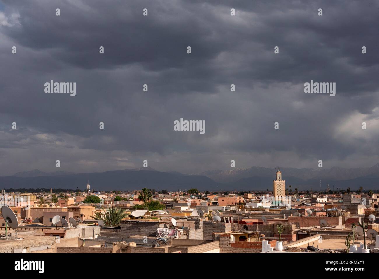 Scenic view of the Marrakech medina and the Atlas mountains in the background during stormy weather, Morocco Stock Photo