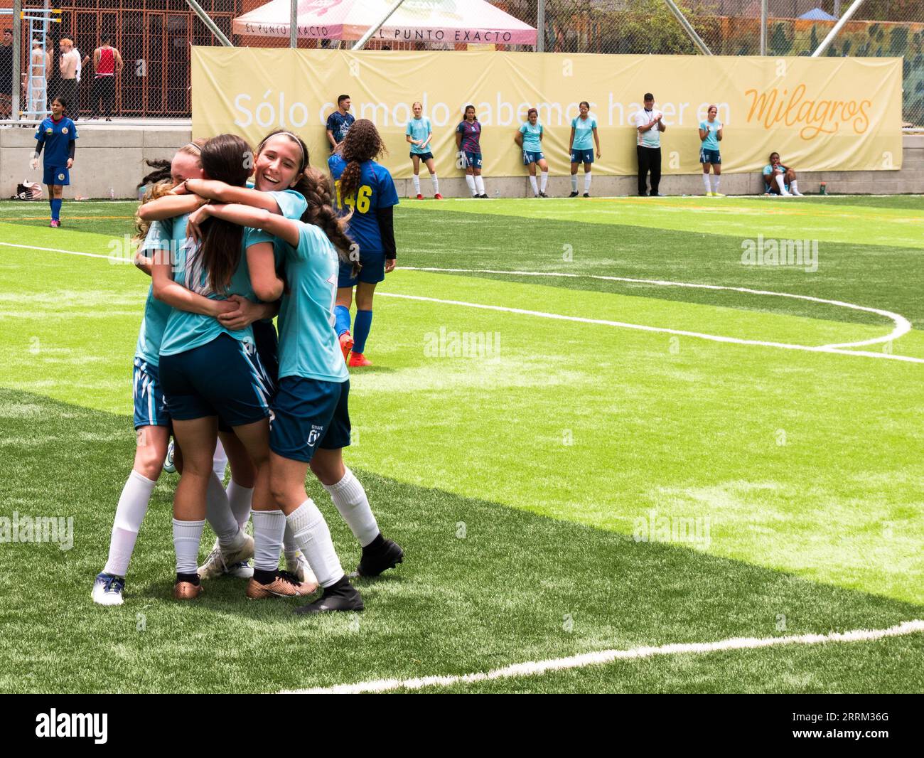 Envigado - 22 april 2023: Girls soccer team celebrating a goal during a school sports tournament Stock Photo