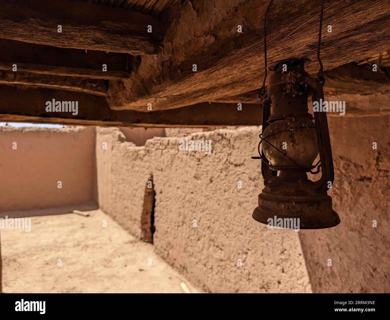 An old gas lamp hanging at the ceiling of a derelict berber house in the village of Amezrou, Morocco Stock Photo