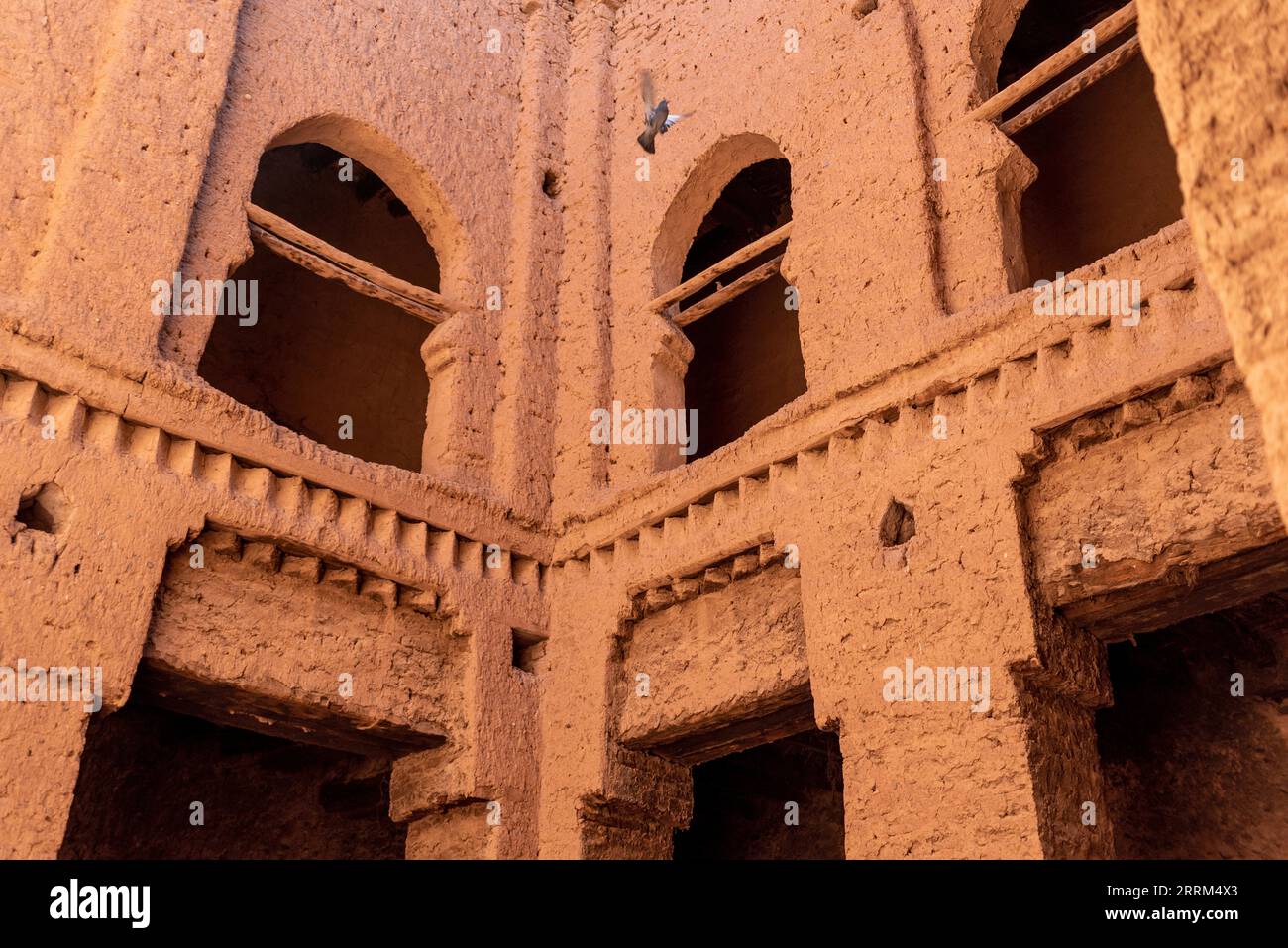 Windows in an inner courtyard of a typcial berber house in a derelict, abandoned house in Tamenougalt in the Draa valley, Morocco Stock Photo
