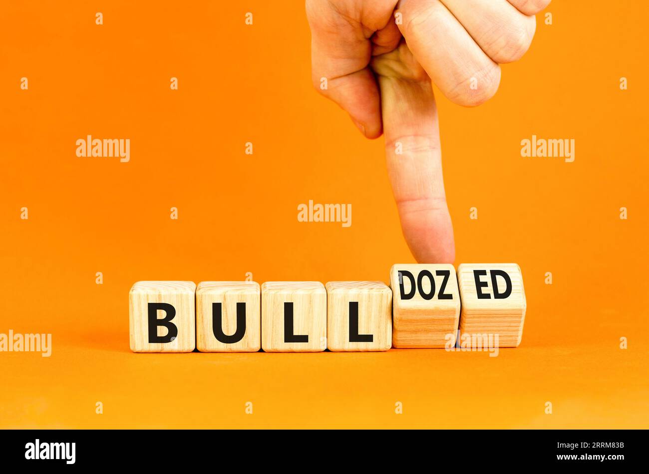 Bull or bulldozed symbol. Businessman turns wooden cubes and changes