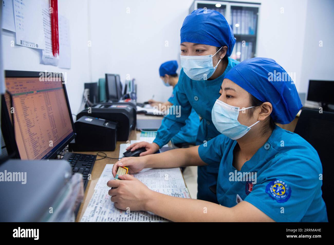 221011 -- CHANGSHA, Oct. 11, 2022 -- Xu Furong C and her colleague check the hospitalization information of patients at an ICU ward nurse station at Hunan Provincial People s Hospital in Changsha, central China s Hunan Province, Sept. 9, 2022. TO GO WITH Profile: Guarding lives of those on brink of death  CHINA-HUNAN-20TH CPC NATIONAL CONGRESS-DELEGATE-ICU NURSE CN ChenxSihan PUBLICATIONxNOTxINxCHN Stock Photo