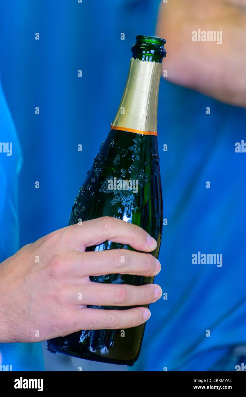 Tasting of sparkling white wine with bubbles champagne on summer