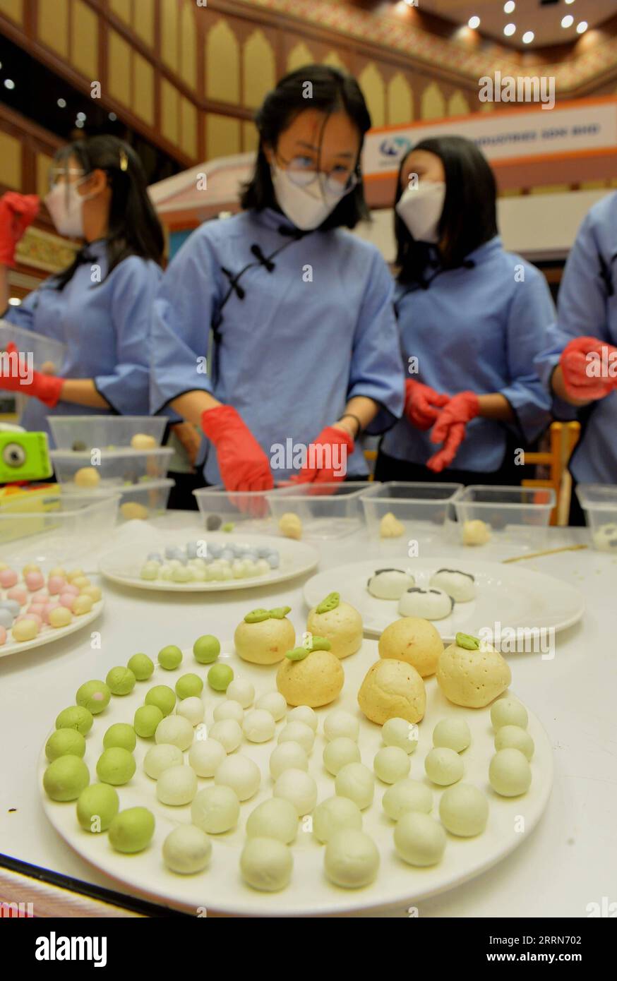 221216 -- BANDAR SERI BEGAWAN, Dec. 16, 2022 -- People make tang-yuan, a traditional Chinese food, during a China Day cultural event in Bandar Seri Begawan, Brunei, on Dec. 16, 2022. The China Day cultural event, as part of the Brunei December Festival, was launched here at the International Convention Center on Friday. A series of activities showcasing Chinese cultures such as wushu, calligraphy, delicacy, and sales of Chinese goods and specialties will be staged during the three-day cultural event. Photo by /Xinhua BRUNEI-BANDAR SERI BEGAWAN-CHINA DAY-CULTURAL EVENT JeffreyxWong PUBLICATIONx Stock Photo