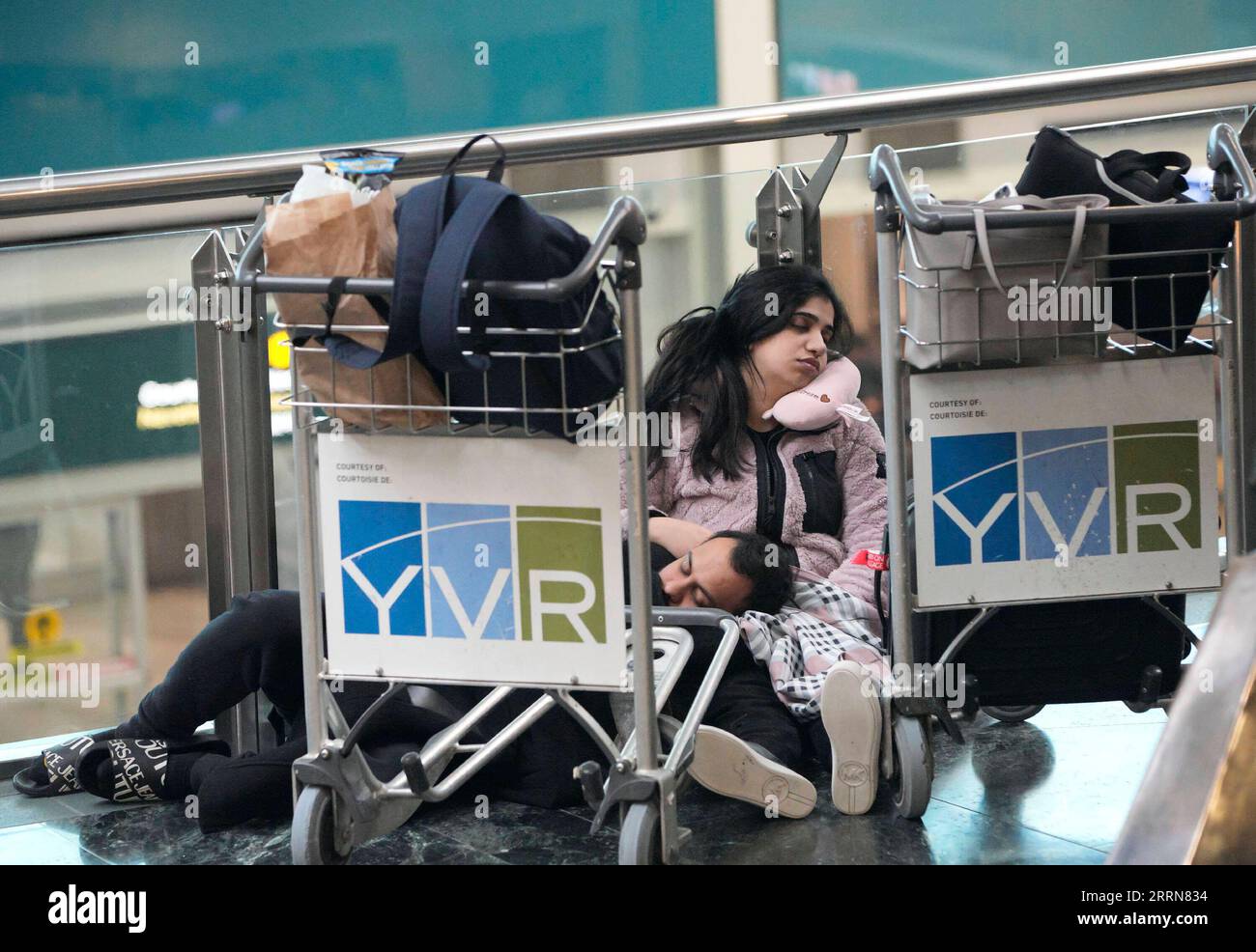 221220 -- RICHMOND CANADA, Dec. 20, 2022 -- People sleep on the floor at Vancouver International Airport in Richmond, British Columbia, Canada, on Dec. 20, 2022. Thousands of travelers were stuck at the Vancouver International Airport on Tuesday as many flights were cancelled or delayed due to the snowstorm. Photo by /Xinhua CANADA-VANCOUVER INTERNATIONAL AIRPORT-SNOWSTORM-STRANDED PASSENGERS LiangxSen PUBLICATIONxNOTxINxCHN Stock Photo