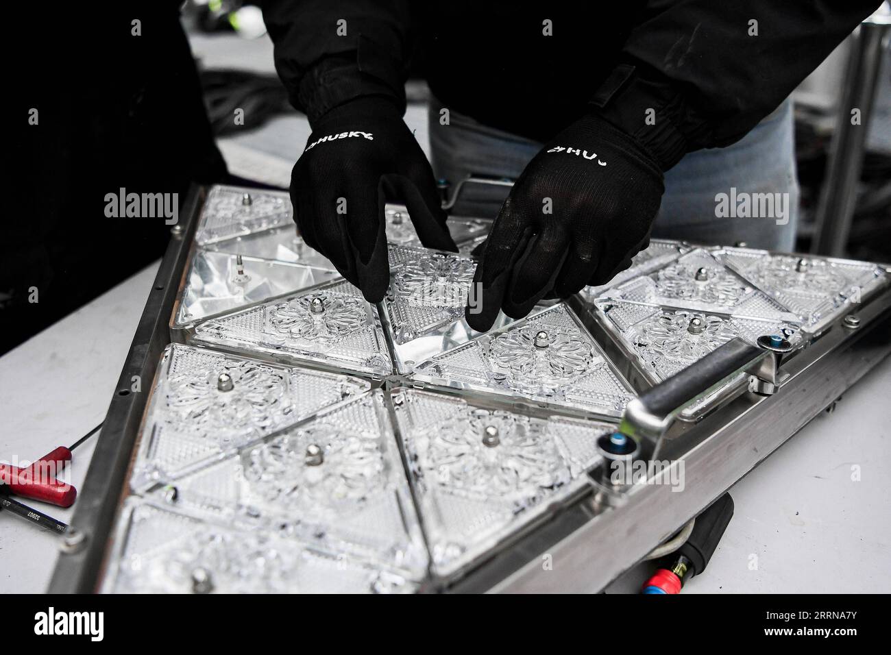 221227 -- NEW YORK, Dec. 27, 2022 -- A piece of crystal is put into a larger pattern during the Crystal Times Square New Year s Ball assembly on the roof of One Times Square, New York, the United States, on Dec. 27, 2022. As part of the yearly tradition, replacement of some of the 2,688 Waterford Crystal triangles on the Times Square New Year s Eve Ball started on Tuesday. The ball, 12 feet in diameter and 11,875 pounds in weight, will begin its descent at 11:59 p.m., Dec. 31, starting the countdown of the final seconds of the year and celebrating the beginning of a new year, at the climax of Stock Photo