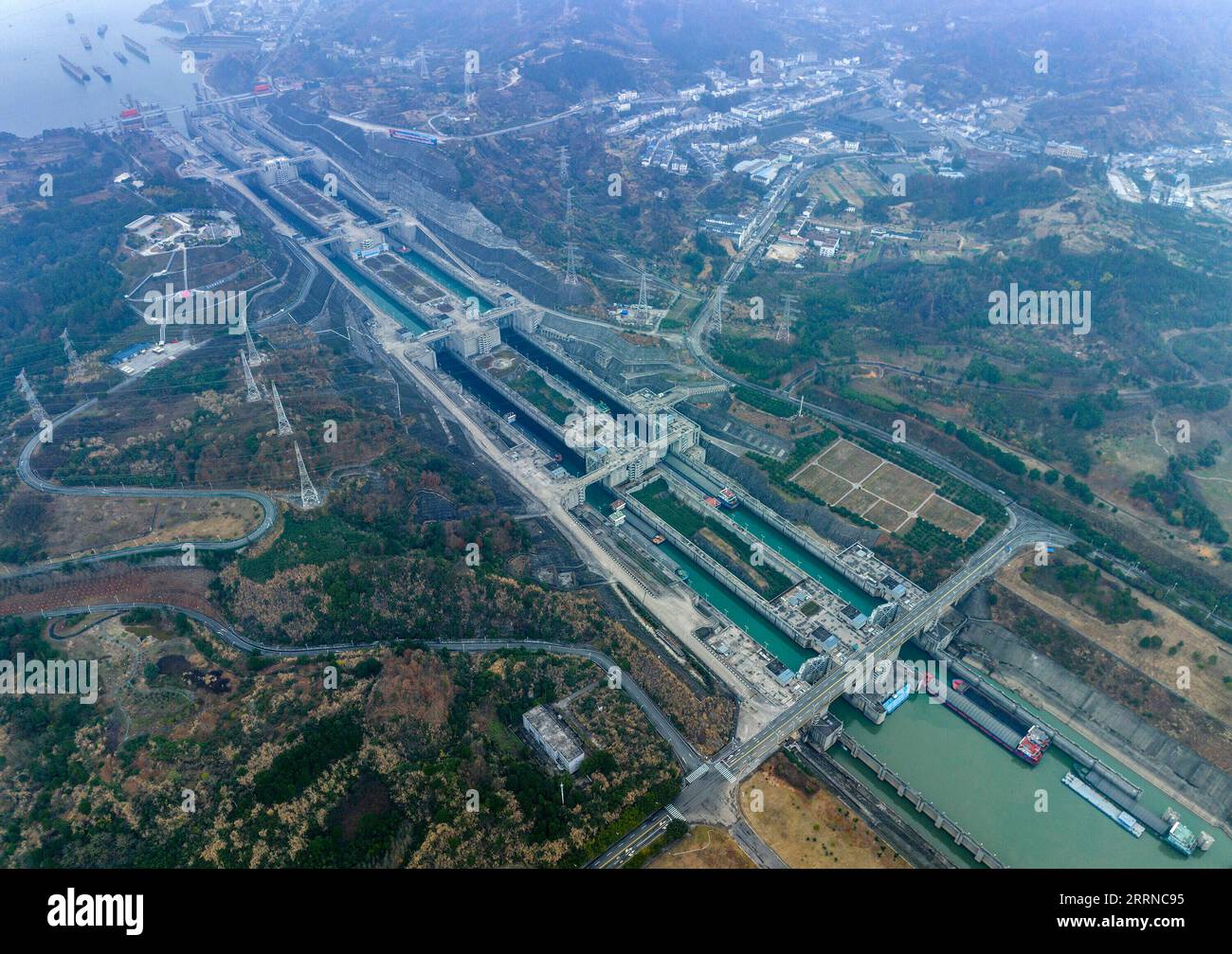 230102 -- YICHANG, Jan. 2, 2023 -- This aerial photo taken on Jan. 2, 2023 shows ships passing through the five-tier ship locks of the Three Gorges Dam in Yichang, central China s Hubei Province. The shipping throughput of the Three Gorges Dam, the world s largest hydropower project, hit a new record in 2022, the Three Gorges Navigation Authority said Monday.  The project s total throughput reached 159.8 million tonnes in 2022, an increase of 6.12 percent year on year.  In 2022, the cargo throughput of the project was 159.65 million tonnes, a year-on-year increase of 6.53 percent. Meanwhile, t Stock Photo