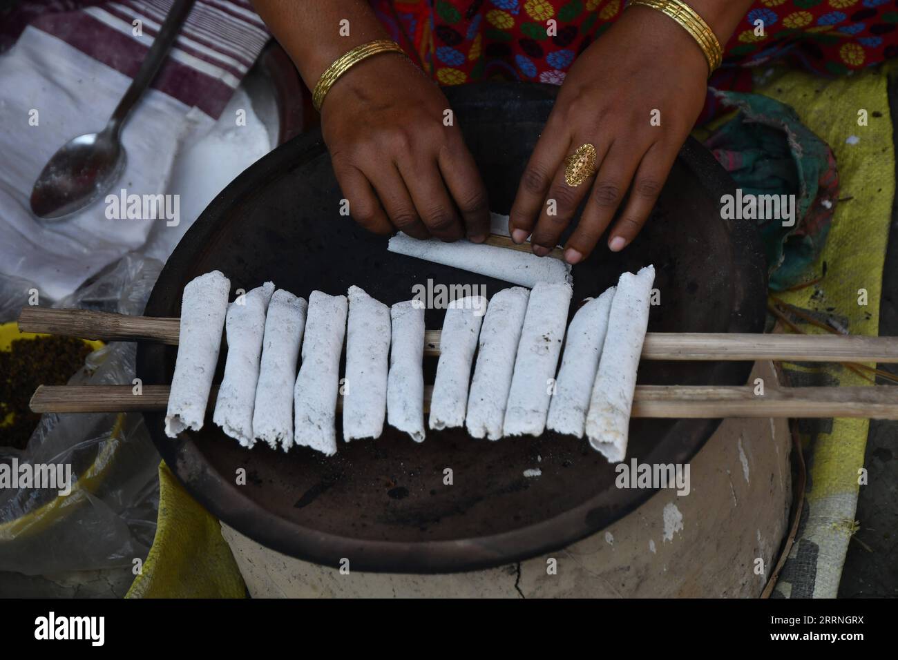 230112 NAGAON Jan 12 2023 A Woman Prepares Traditional Food 