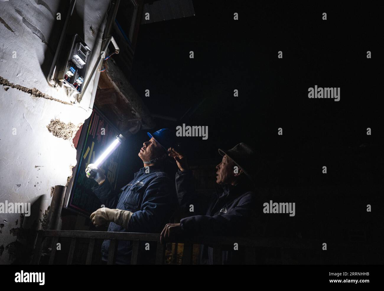 230114 -- DEQEN, Jan. 14, 2023 -- Wangden inspects power lines in Yubeng Village of Deqen County, southwest China s Yunnan Province, Jan. 8, 2023. Wangden, 34, is the associate director of the Yunnan branch of China Southern Power Grid s Yanmen power supply station in Deqen County. In 2015, he was assigned to take charge of maintenance tasks in Yubeng, a local village lying at the foot of snow-capped mountains. As Yubeng s longest-serving power supply worker, the man has witnessed tremendous changes in the village. In the past, Yubeng was virtually cut off from the outside world, with no elect Stock Photo