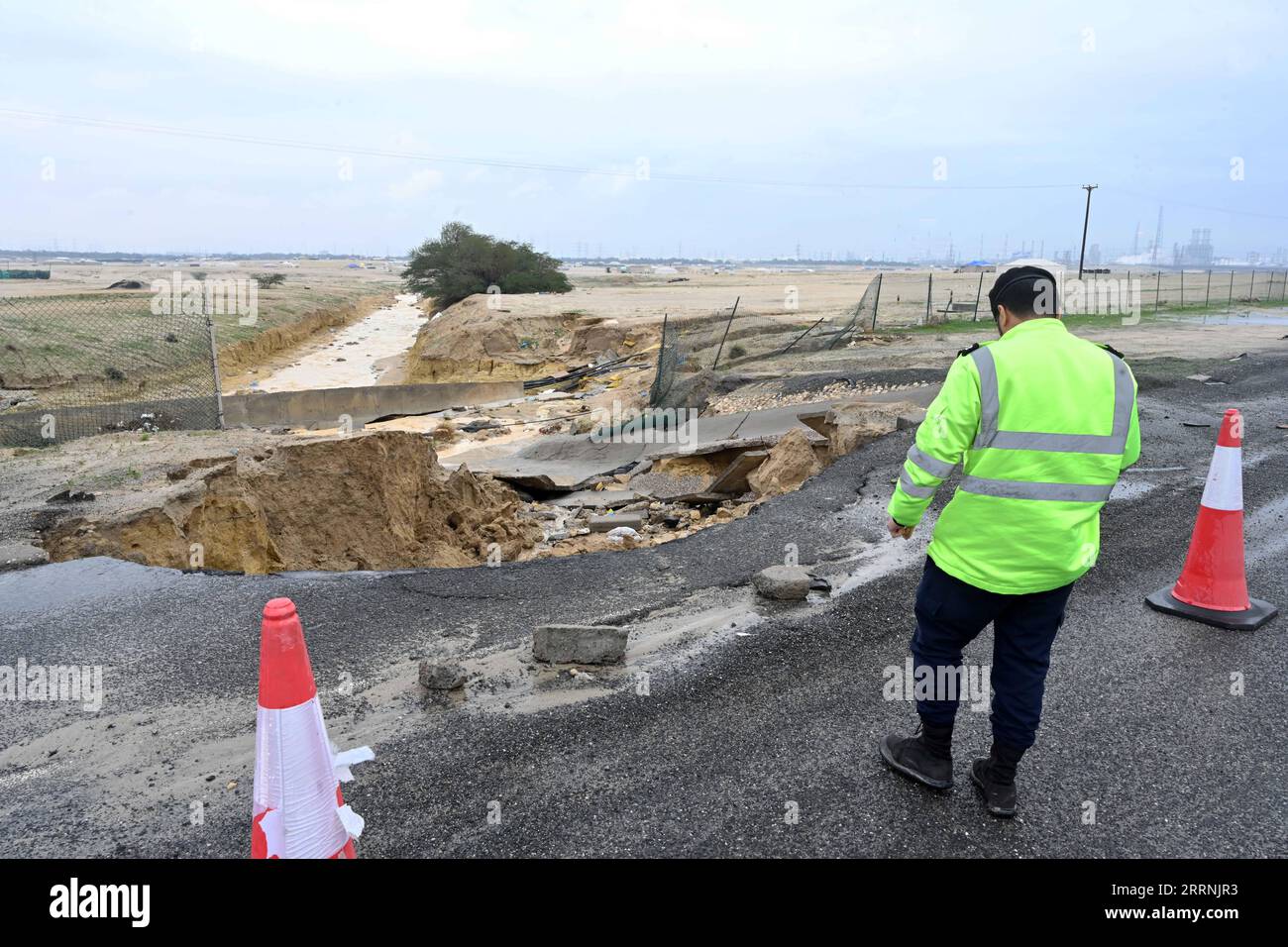 230117 -- KUWAIT CITY, Jan. 17, 2023 -- A police officer checks a road damaged during a rainstorm in Ahmadi Governorate, Kuwait, Jan. 17, 2023. Photo by /Xinhua KUWAIT-RAIN Asad PUBLICATIONxNOTxINxCHN Stock Photo