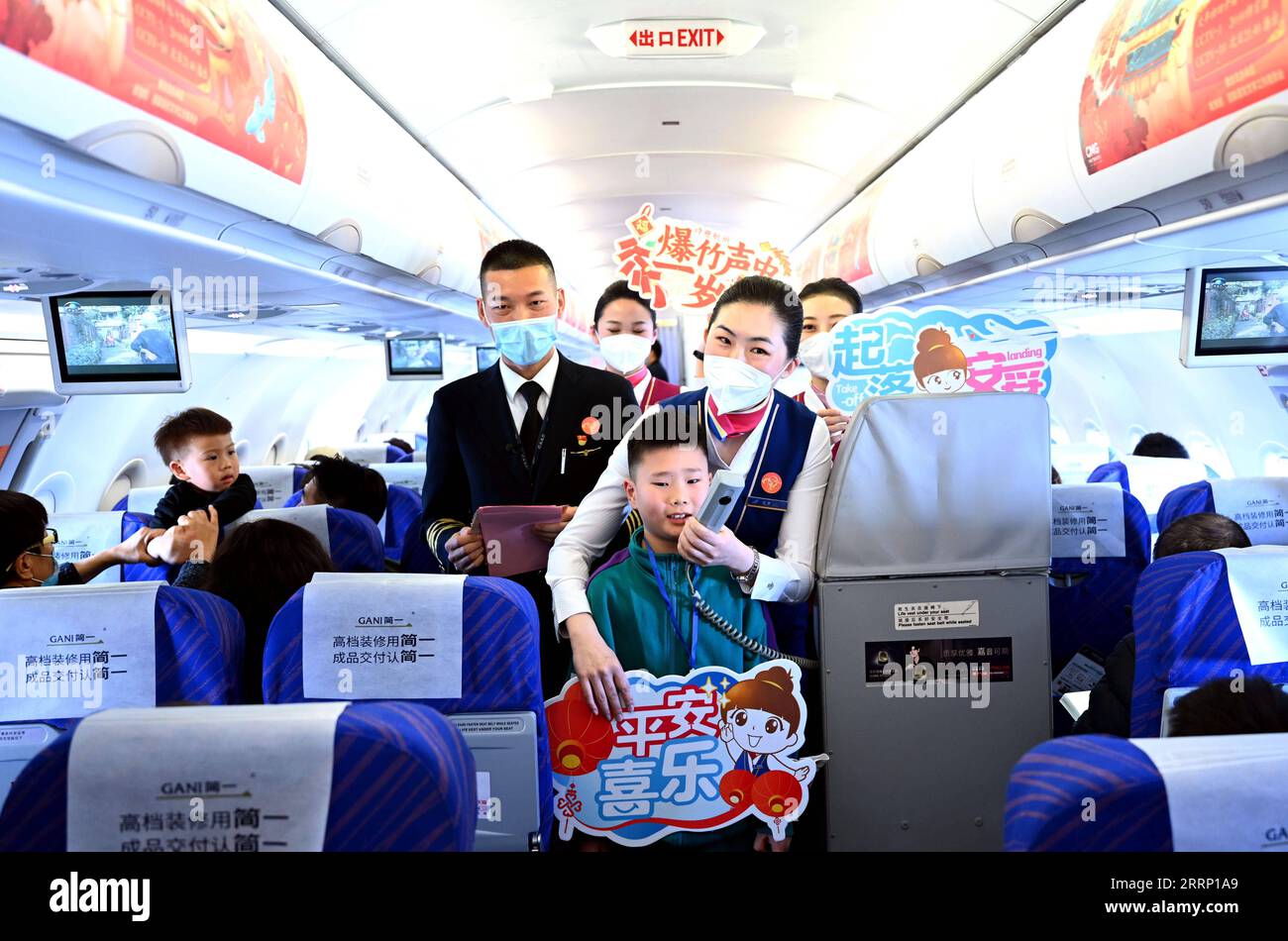 230210 -- DALIAN, Feb. 10, 2023 -- Ma Baoli plays a spring themed ancient poetry citing game with passengers during a flight from Dalian of northeast China s Liaoning Province to Guangzhou of south China s Guangdong Province, Feb. 4, 2023. Captain Ma Baoli, 35, has a great passion for Chinese classical poems. From 2018 onwards, Ma has been participating in the Chinese Classical Poetry Quiz Show every year, and won the championship this year. Ma s love for Chinese classical poems was nurtured by his father since childhood. As a graduate of Nanjing University of Aeronautics and Astronautics, Ma Stock Photo