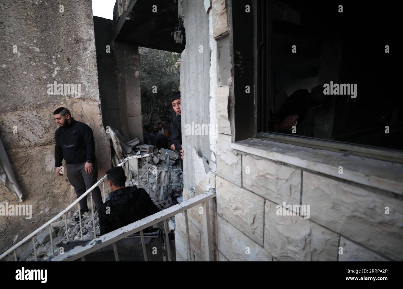 Jenin Checkpoint 230308 -- JENIN, March 8, 2023 -- Palestinians check a house damaged ...