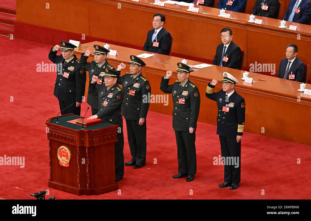 230311 -- BEIJING, March 11, 2023 -- Vice chairmen and members of the Central Military Commission CMC of the People s Republic of China PRC pledge allegiance to the Constitution at the Great Hall of the People in Beijing, capital of China, March 11, 2023. Zhang Youxia and He Weidong were endorsed as the PRC CMC vice chairmen, and Li Shangfu, Liu Zhenli, Miao Hua and Zhang Shengmin as the PRC CMC members at a plenary meeting of the first session of the 14th National People s Congress. Nearly 3,000 deputies to the 14th National People s Congress voted to approve the nomination by Xi Jinping, cha Stock Photo