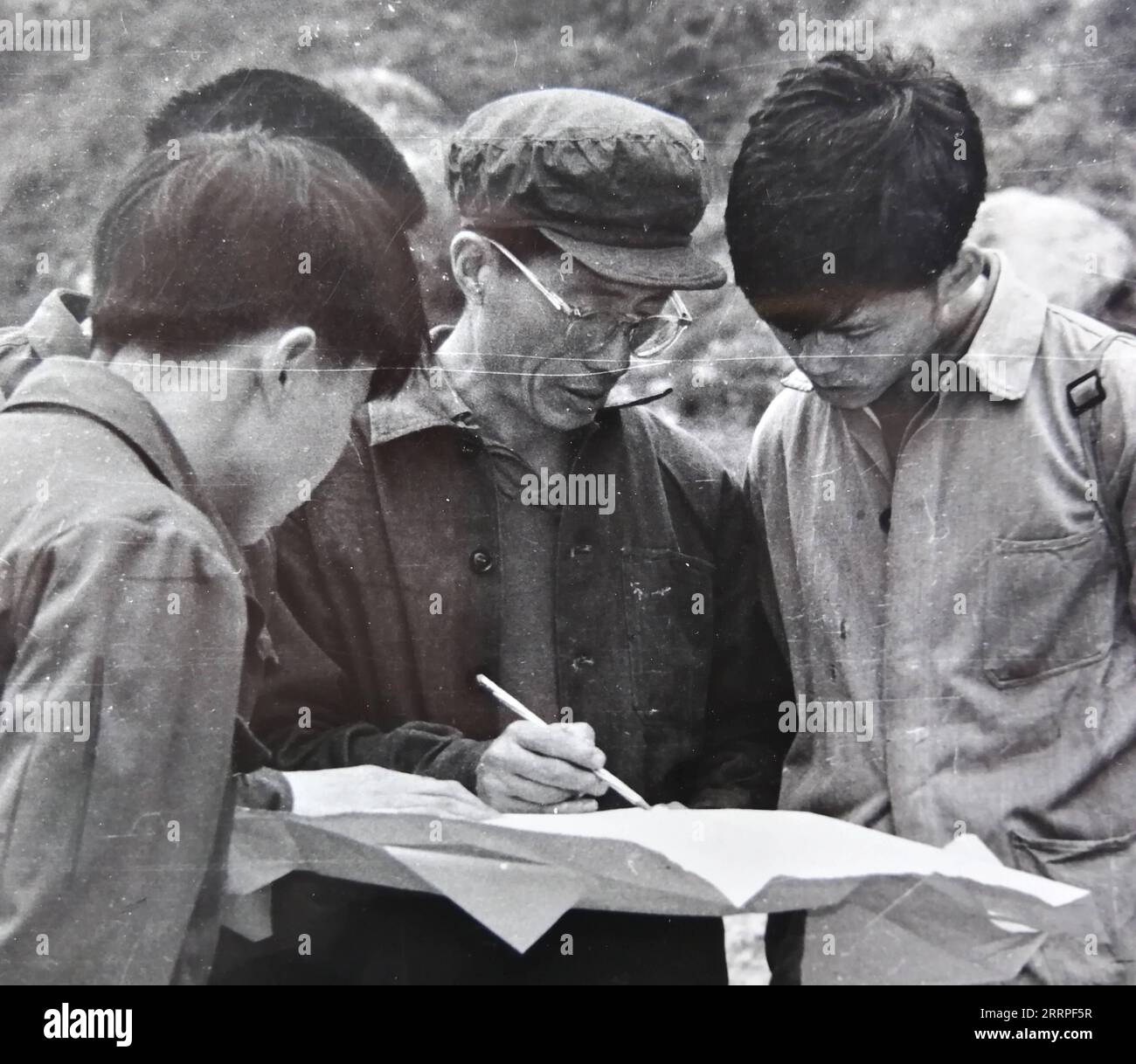 230320 -- CHENGDU, March 20, 2023 -- This file photo taken in 1974 shows Wu Xichun C conducting field research in the northwestern part of Sichuan Province, southwest China. WuXichunisaprofessor at the CollegeofEnergyof theChengduUniversityofTechnology and an expert in geology. Intheearly1970s,while conducting a geological mapping survey in thenorthwesternpartofSichuanProvince, WuunexpectedlydiscoveredareefgroupformedbyTriassicsiliceoushexactinellidsponges. Since then,hehasdevotedhimselftothestudyonspongereefsfornearlyfive decades. Inorder to study foreign literature, Wu mastered English, Russ Stock Photo