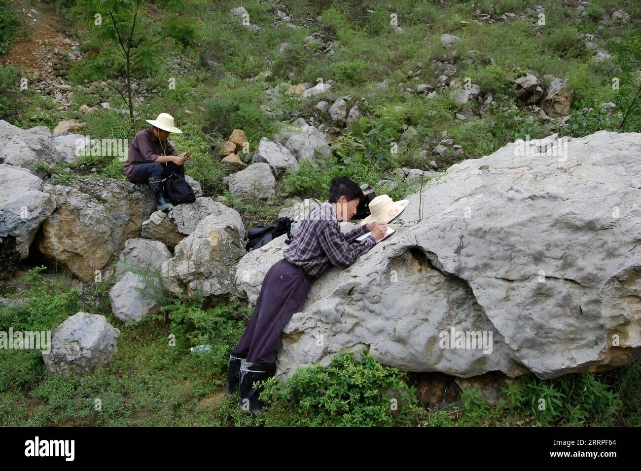 230320 -- CHENGDU, March 20, 2023 -- This file photo taken in 2008 shows Wu Xichun R conducting field research in the northwestern part of Sichuan Province, southwest China. WuXichunisaprofessor at the CollegeofEnergyof theChengduUniversityofTechnology and an expert in geology. Intheearly1970s,while conducting a geological mapping survey in thenorthwesternpartofSichuanProvince, WuunexpectedlydiscoveredareefgroupformedbyTriassicsiliceoushexactinellidsponges. Since then,hehasdevotedhimselftothestudyonspongereefsfornearlyfive decades. Inorder to study foreign literature, Wu mastered English, Russ Stock Photo