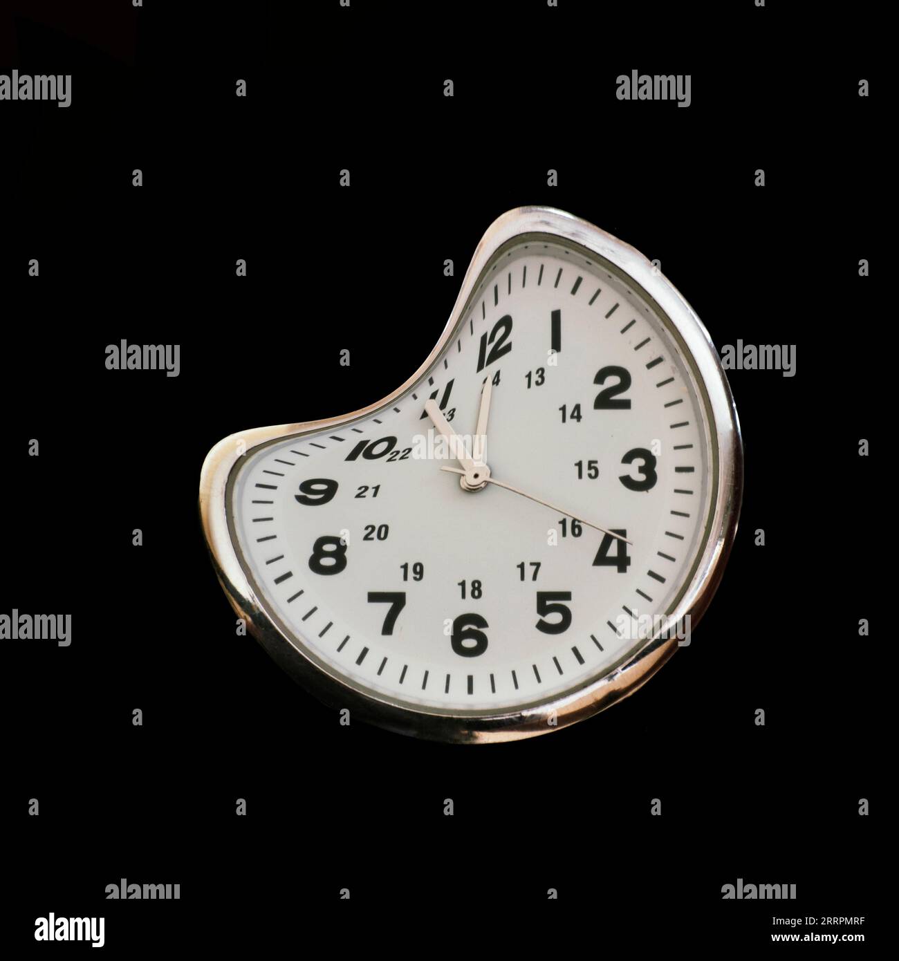 Time warped a distorted 24 hour clock face isolated on black Stock