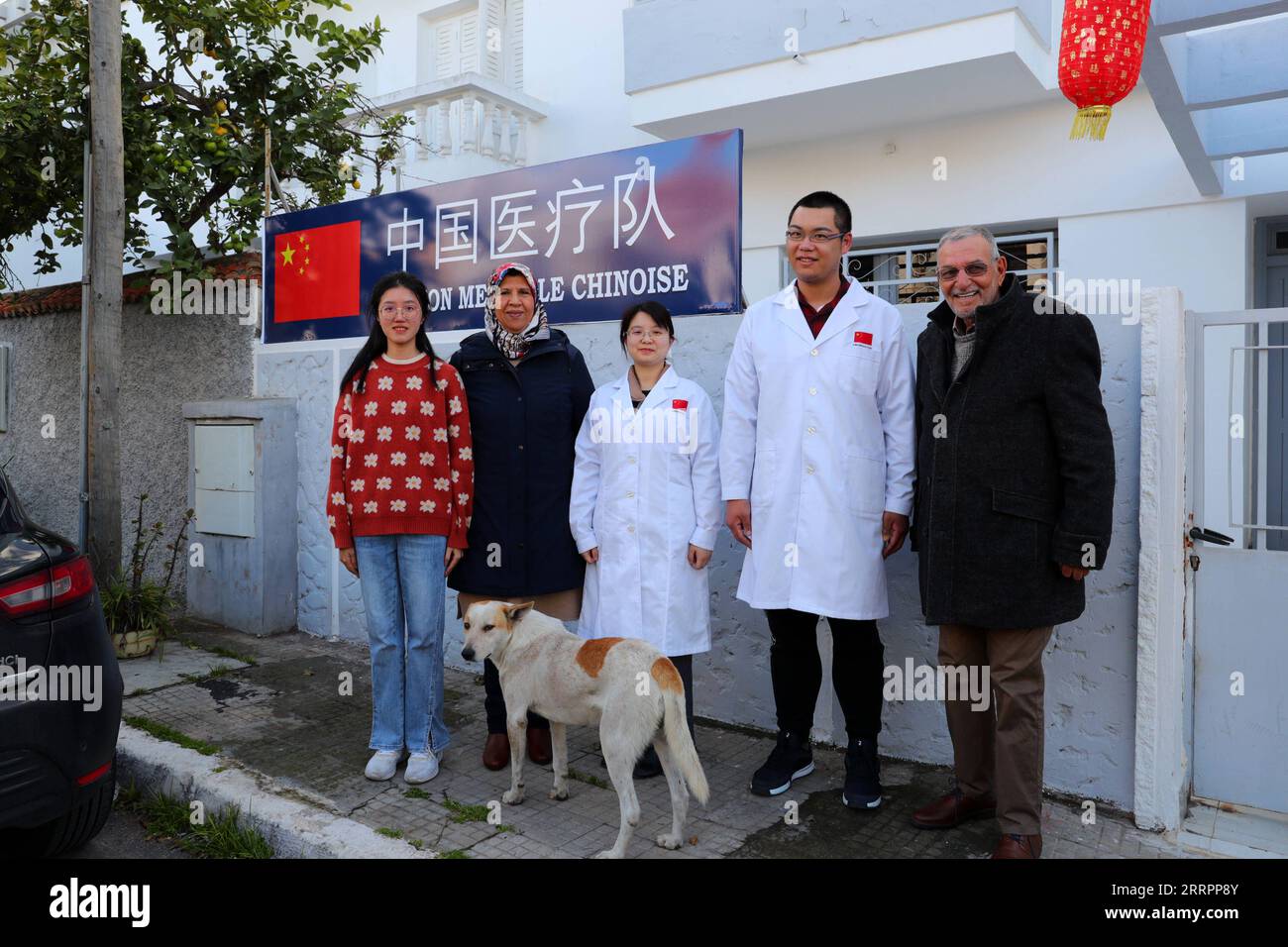 230405 -- MOHAMMEDIA MOROCCO, April 5, 2023 -- Members of a Chinese medical team in Mohammedia pose for a group photo with Arihe Maan 1st R who comes for acupuncture therapy in Mohammedia, Morocco, on Feb. 27, 2023. For nearly half a century, Chinese doctors, mainly obstetrician-gynecologists, have earned a sterling reputation for their professionalism and dedication in some remote areas of Morocco. Many pregnant women from across the country come to seek medical advice and childbirth care from them.  TO GO WITH Feature: Chinese doctors win hearts, applause with professionalism, dedication in Stock Photo
