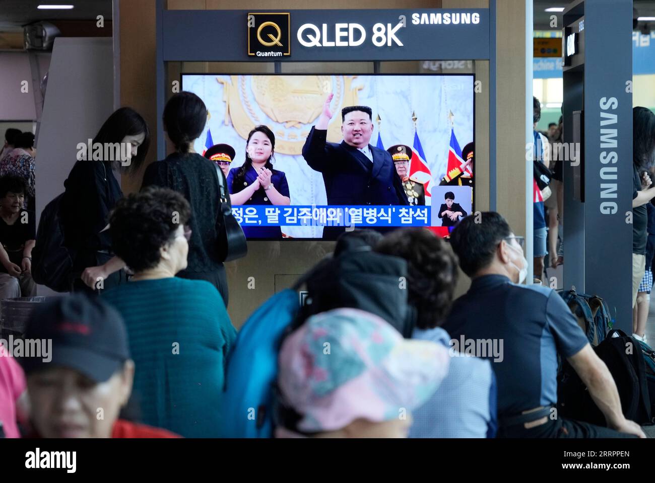 a-tv-screen-shows-an-image-of-north-korean-leader-kim-jong-un-and-his