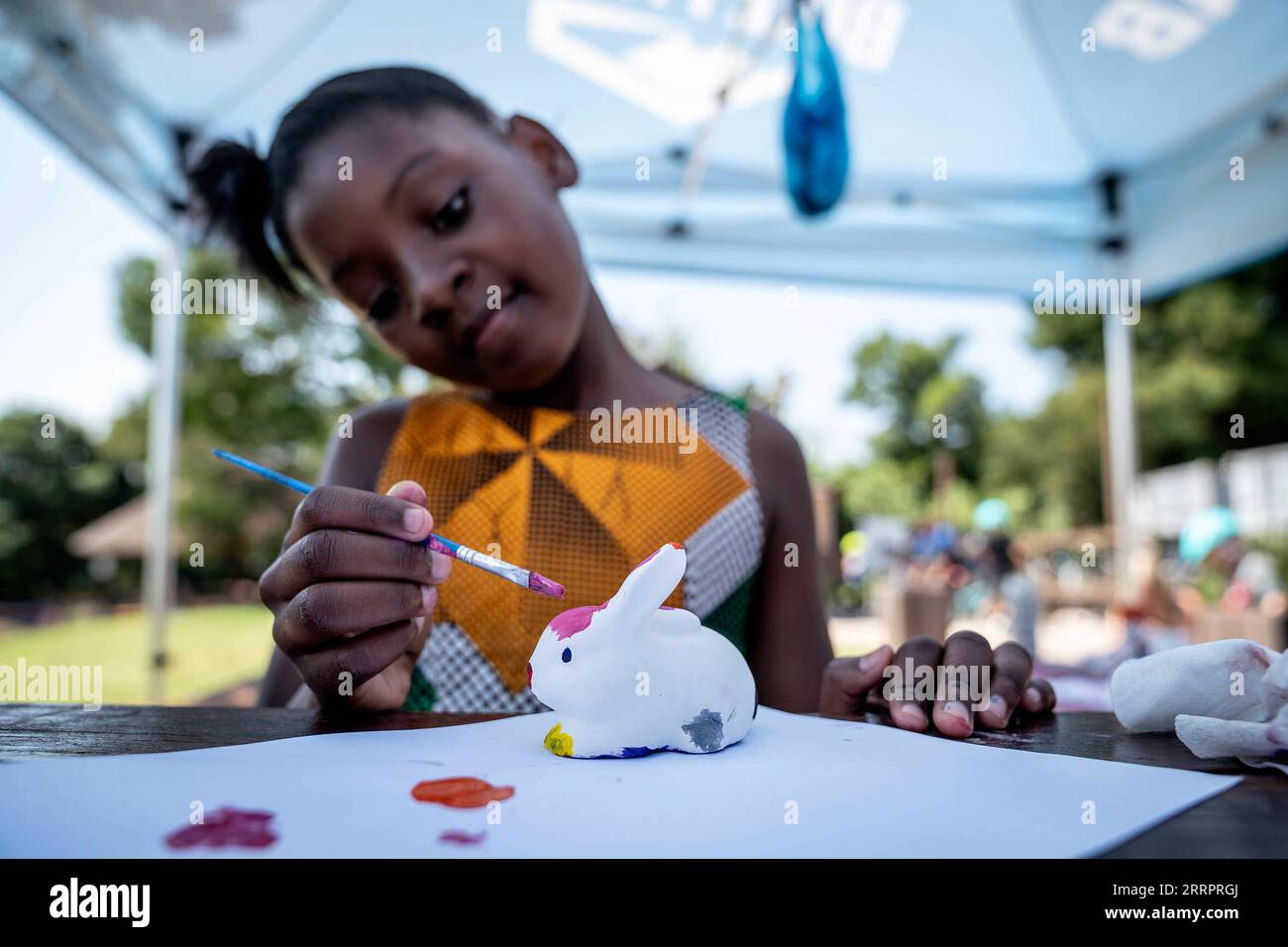 230408 -- JOHANNESBURG, April 8, 2023 -- A girl paints a rabbit toy during an event to celebrate Easter at a park in Johannesburg, South Africa, April 8, 2023. Various activities were held in Johannesburg to mark the upcoming Easter. Photo by /Xinhua SOUTH AFRICA-JOHANNESBURG-EASTER-EVENTS ShiraazxMohamed PUBLICATIONxNOTxINxCHN Stock Photo