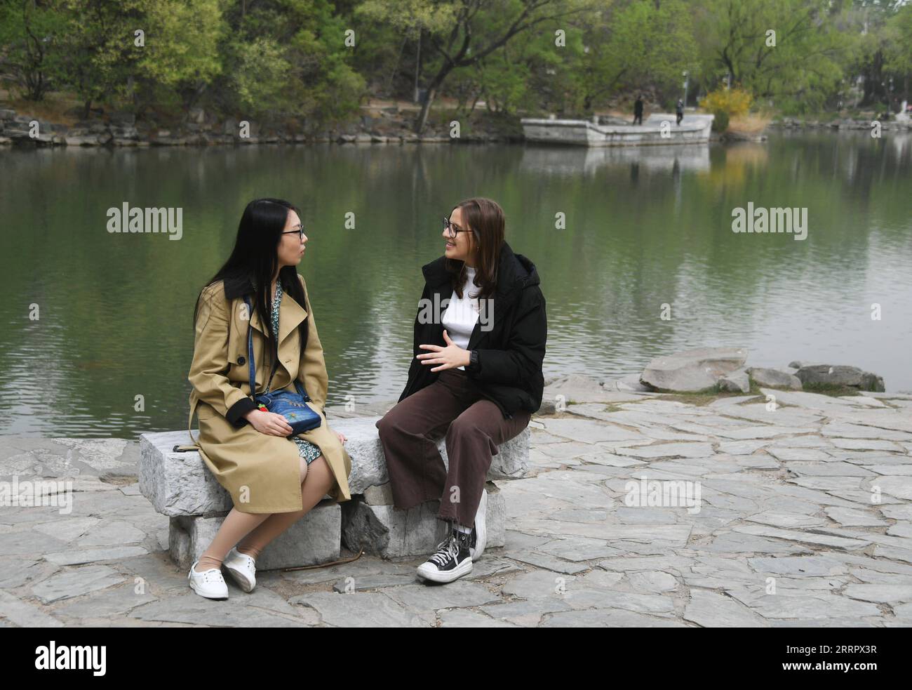 230415 -- BEIJING, April 15, 2023 -- Maria R chats with her language partner Yin Yue, a student majoring in Teaching Chinese as a Second Language, at Peking University in Beijing, capital of China, April 13, 2023. Maria Eduarda Variani, Rafaela Viana dos Santos, Manuela Boiteux Pestana, and Marco Andre Rocha Germano are Brazilian students studying in the Master of China Studies program at the Yenching Academy of Peking University in China. The four of them have been interested in Chinese culture since they were young. After arriving in Beijing, they have been impressed by the Chinese capital s Stock Photo