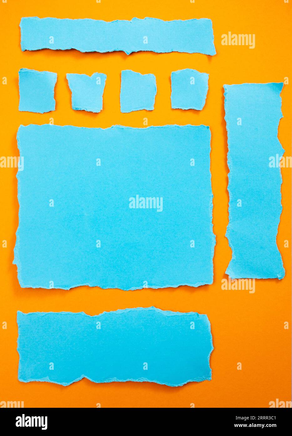 Ripped blue paper strips on orange  background, arranged as webpage elements Stock Photo