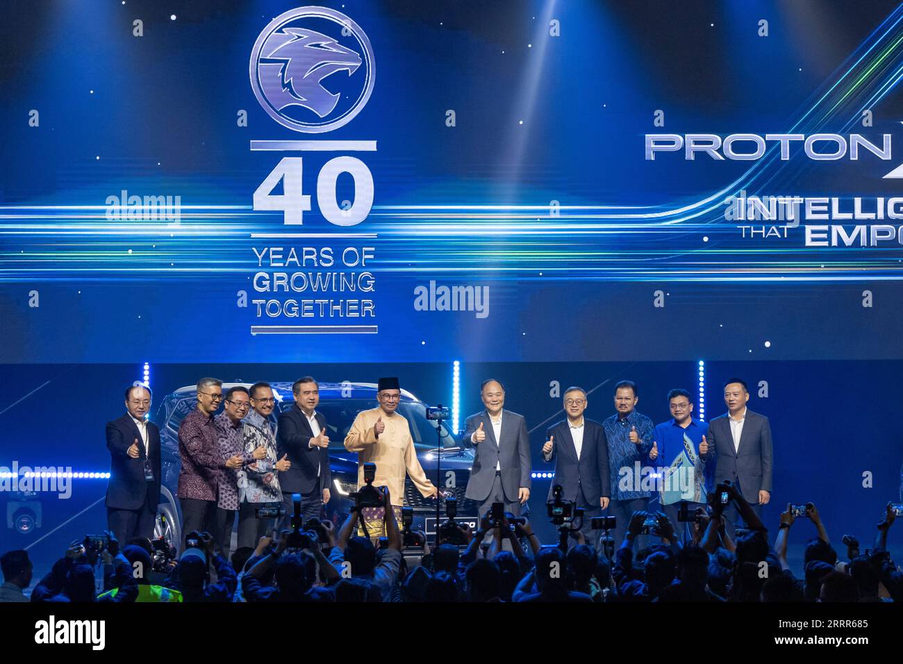 230508 -- KUALA LUMPUR, May 8, 2023 -- Malaysian Prime Minister Anwar Ibrahim C, chairman of Geely Holding Group Li Shufu 5th R and guests pose for photos at the official launch of Proton s newest model, the Proton X90 sports utility vehicle SUV, in Kuala Lumpur, Malaysia, May 7, 2023. The continued partnership and close collaboration between Malaysian national carmaker Proton and China s Geely are of strategic importance, Malaysian Prime Minister Anwar Ibrahim said on Sunday. The collaboration accelerates the adoption of electric vehicles EV and hybrid electric vehicles HEV as well as the sup Stock Photo