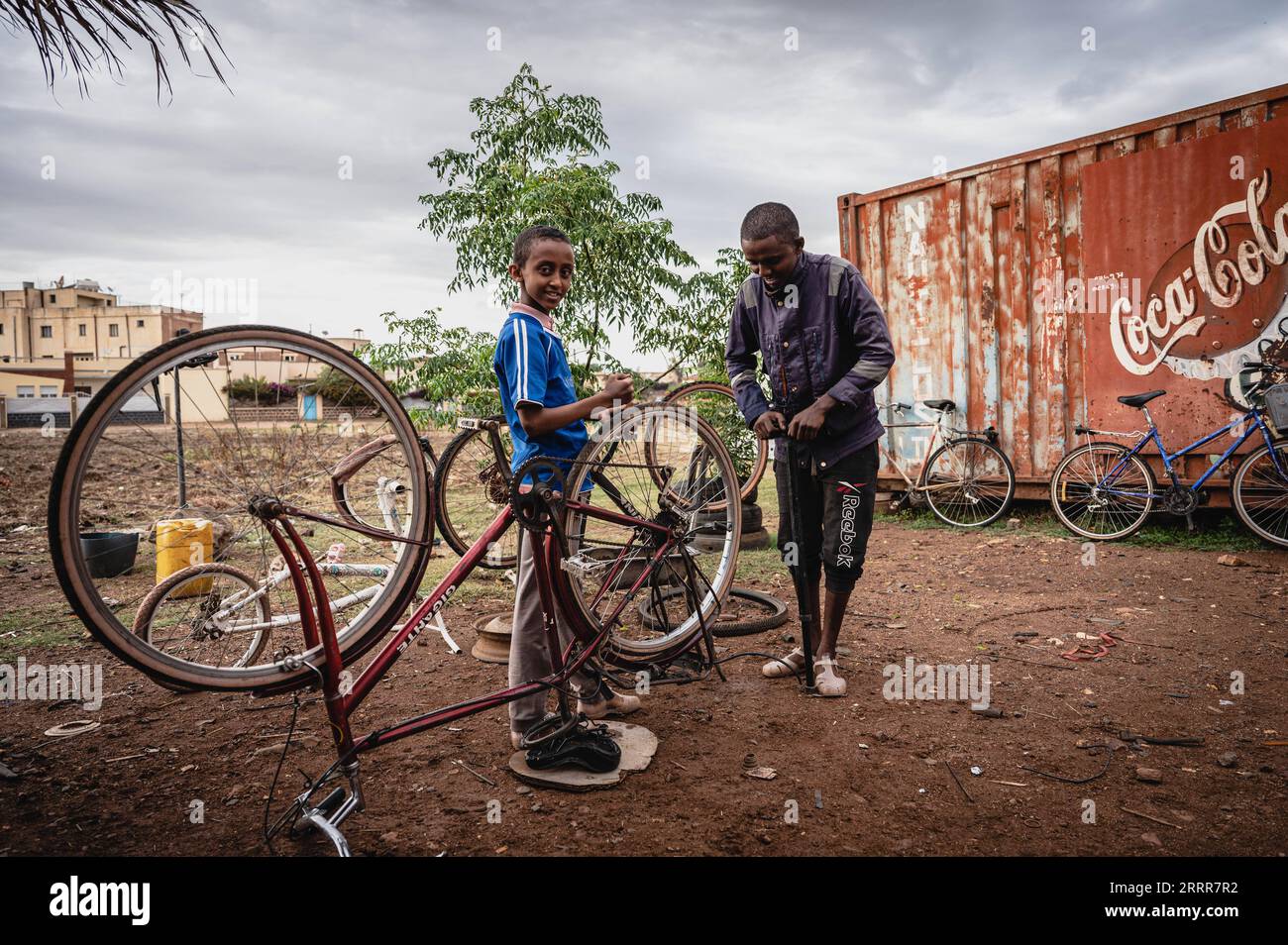 230512 -- ASMARA, May 12, 2023 -- Children repair bikes in Asmara