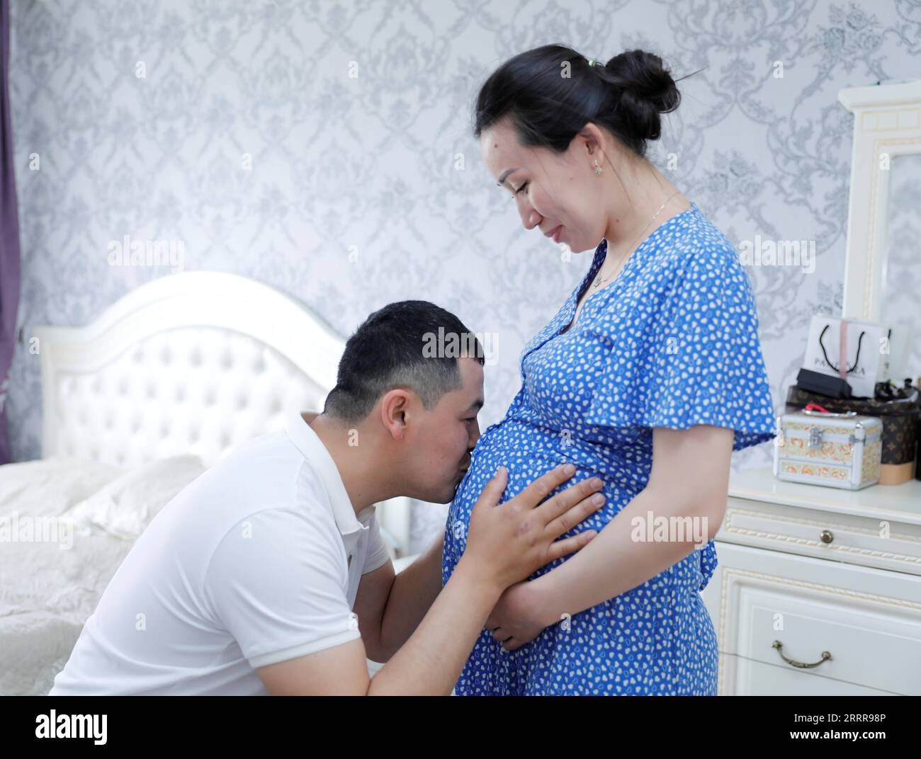 230517 -- ZHANATAS, May 17, 2023 -- Maksat Abilgaziev L interacts with his pregnant wife at his residence in Zhanatas, Kazakhstan, on April 3, 2023. China and Kazakhstan are pioneers in production capacity and investment cooperation, under the framework of the synergy between the Belt and Road Initiative and Kazakhstan s Bright Road new economic policy. The cooperation list includes 52 projects worth a total of more than 21.2 billion U.S. dollars. The 100-MW Zhanatas wind farm is one of the first batch of key energy projects under the China-Kazakhstan production capacity cooperation framework. Stock Photo