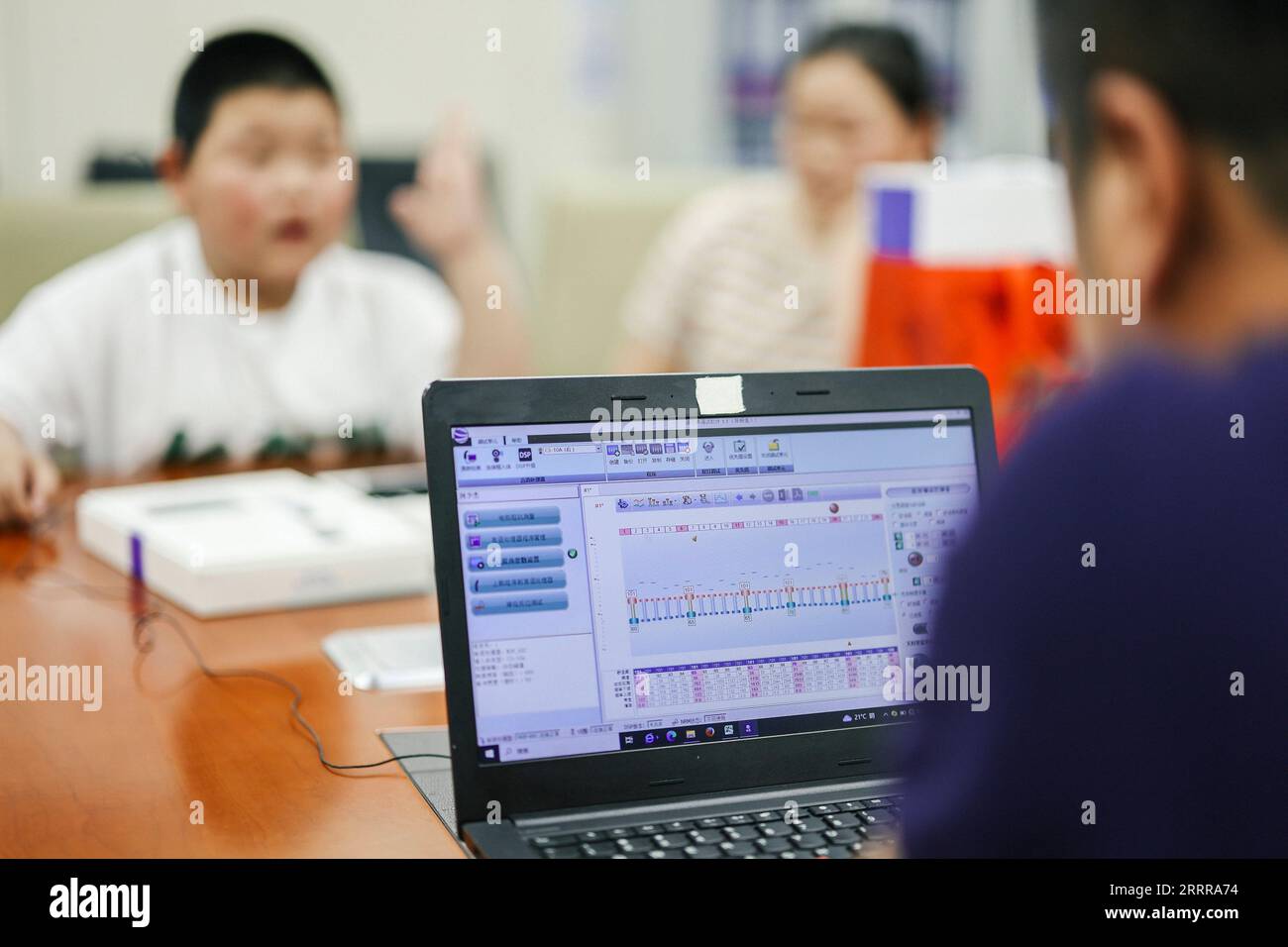 230518 -- CHANGCHUN, May 18, 2023 -- A child raises his hand to indicate that he hears a sound when a cochlear implant is turned on for the first time, in Changchun, northeast China s Jilin Province, May 15, 2023. In recent years, Jilin Province has continued to improve the policy of rehabilitation and treatment for hearing-impaired children, and has provided free cochlear implant operations for more than 1,000 children.  CHINA-JILIN-CHANGCHUN-HEARING-IMPAIRED-CHILDREN CN XuxChang PUBLICATIONxNOTxINxCHN Stock Photo